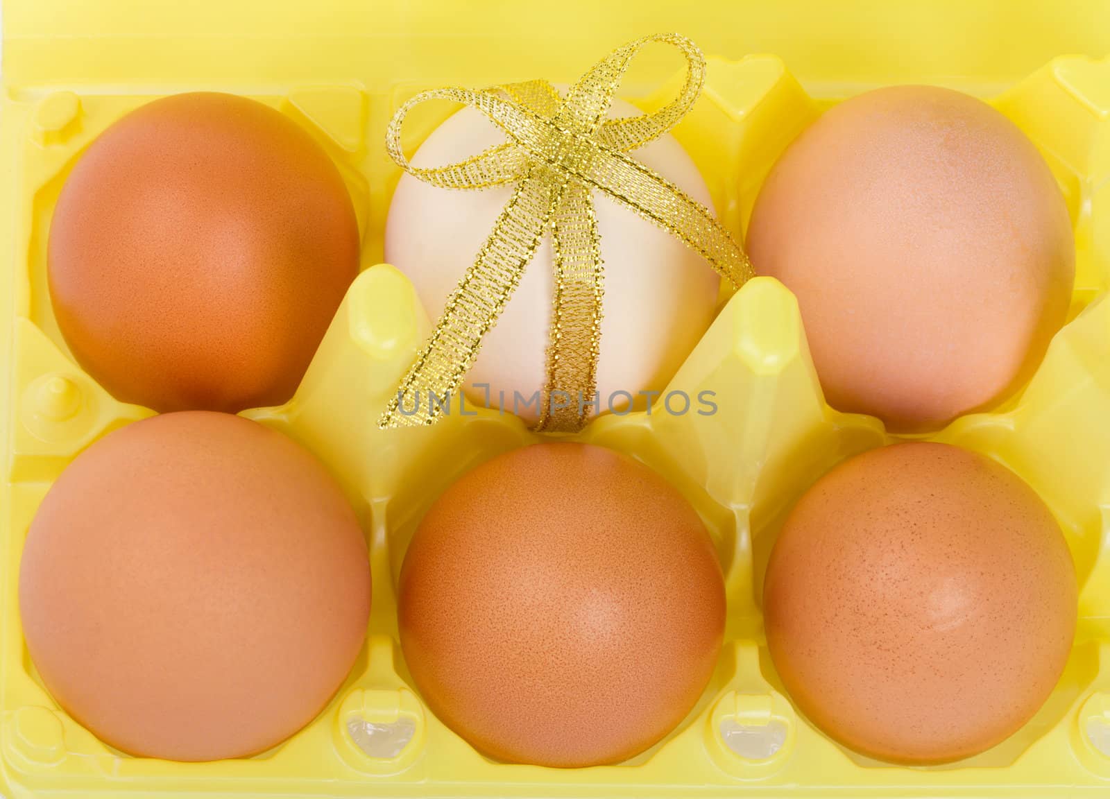 close-up eggs with decoration in container, isolated on white