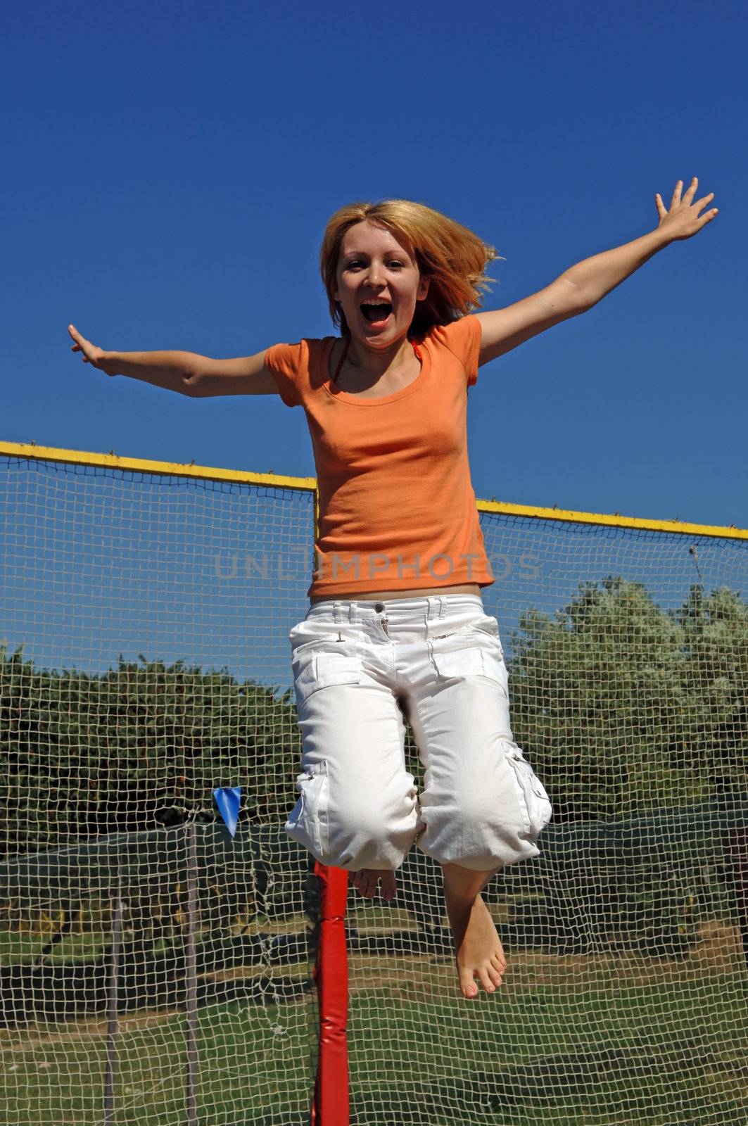 Girl Jumping on Trampoline by adamr