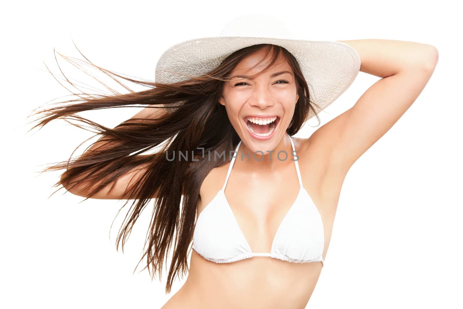 Summer bikini woman isolated in studio. Very energetic fresh portrait of young woman smiling in white bikini and beach hat. Beautiful mixed race Asian Caucasian model isolated on white background.