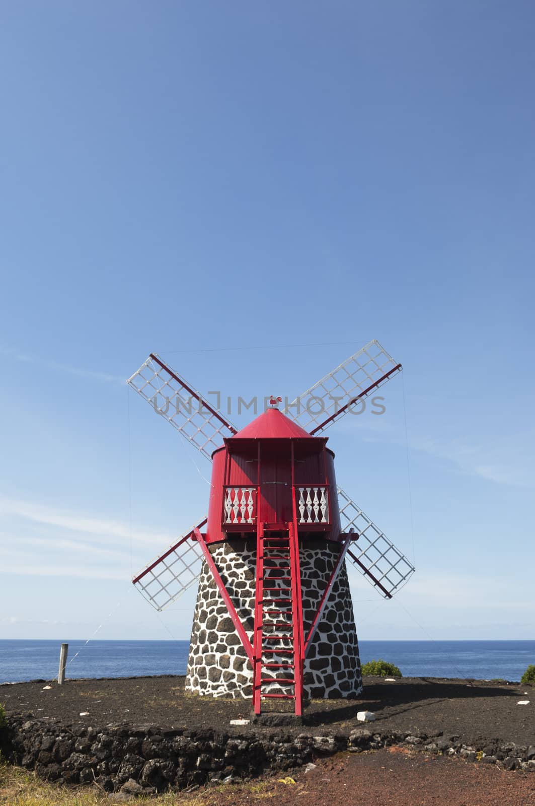 Red windmill in the coast of Pico island, Azores