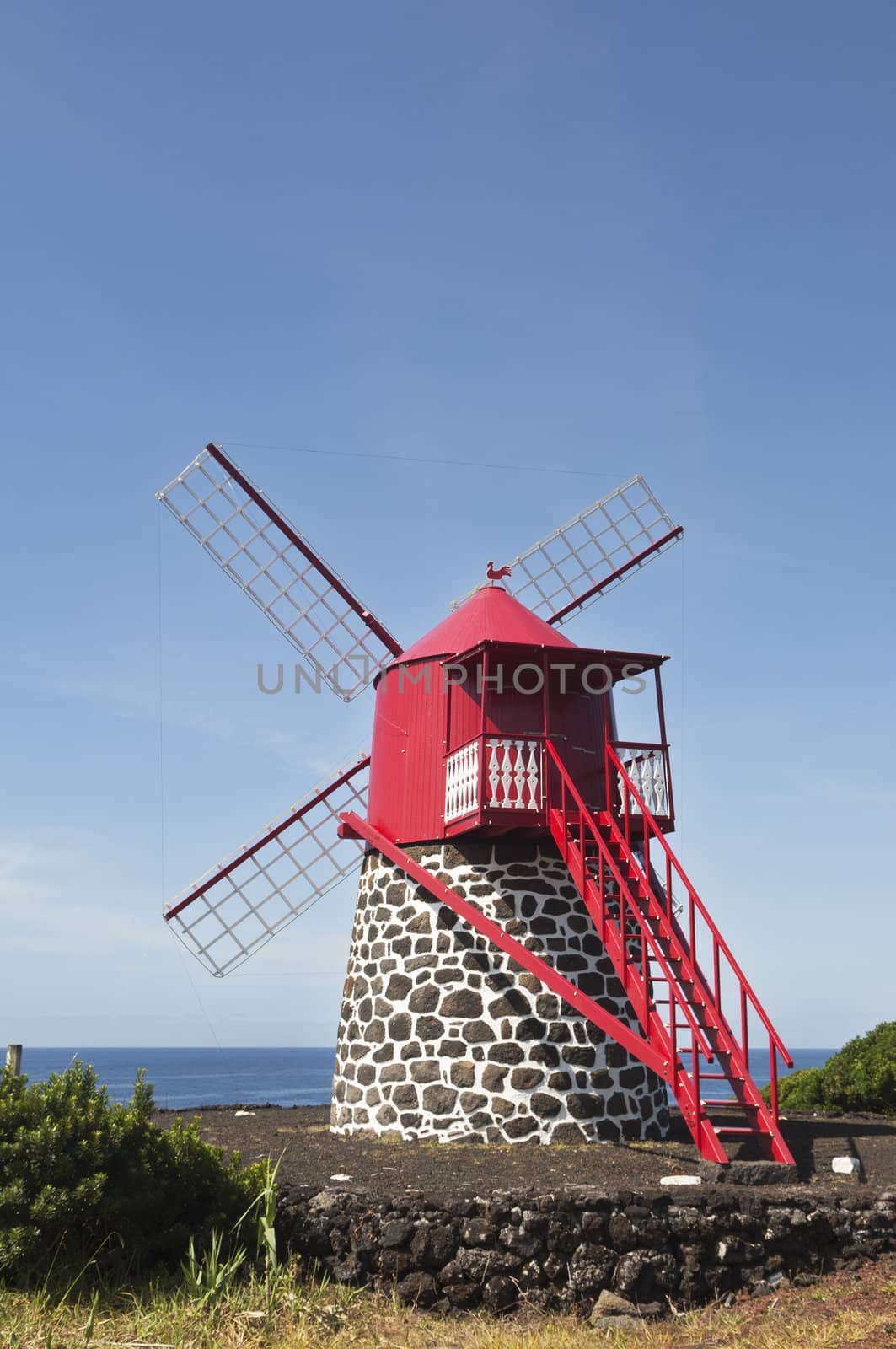 Red windmill in the coast of Pico island, Azores