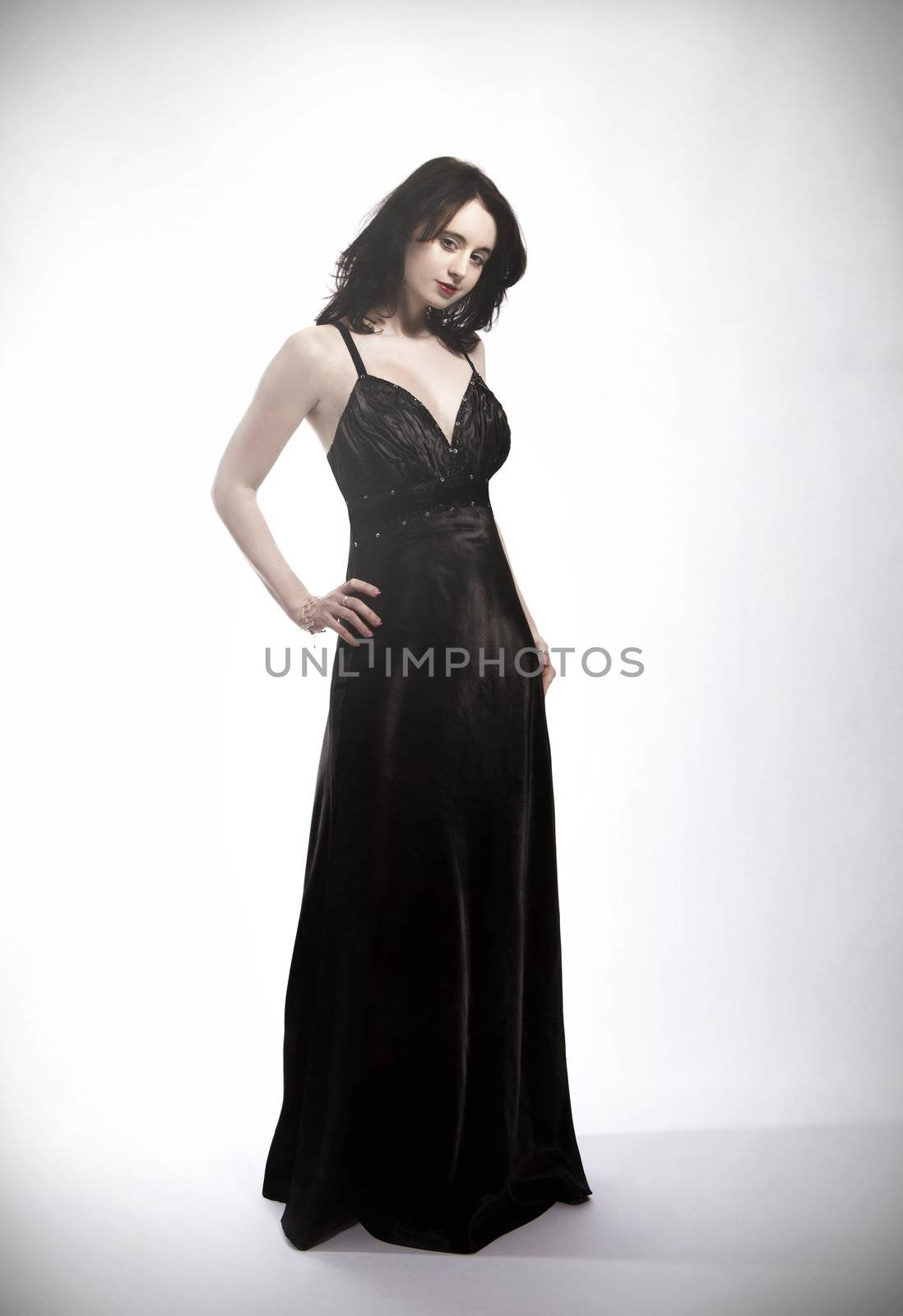 standing young beautiful woman in black dress