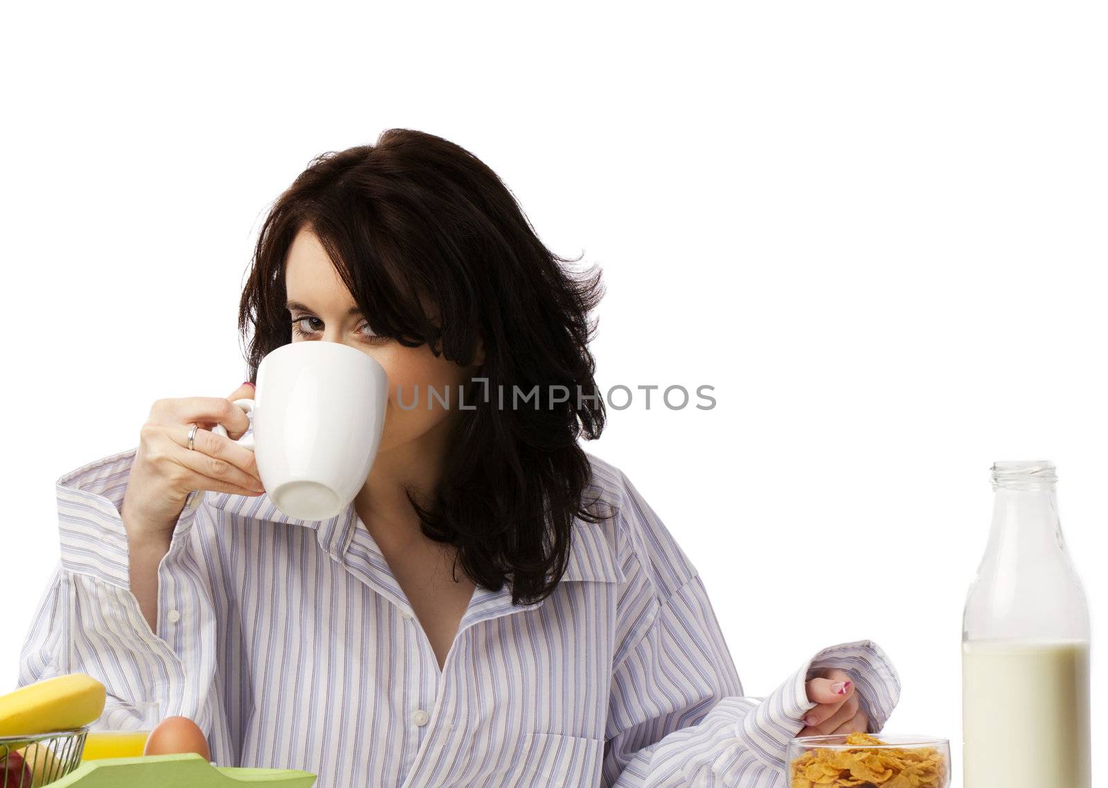 young woman at breakfast drinking coffee by RobStark