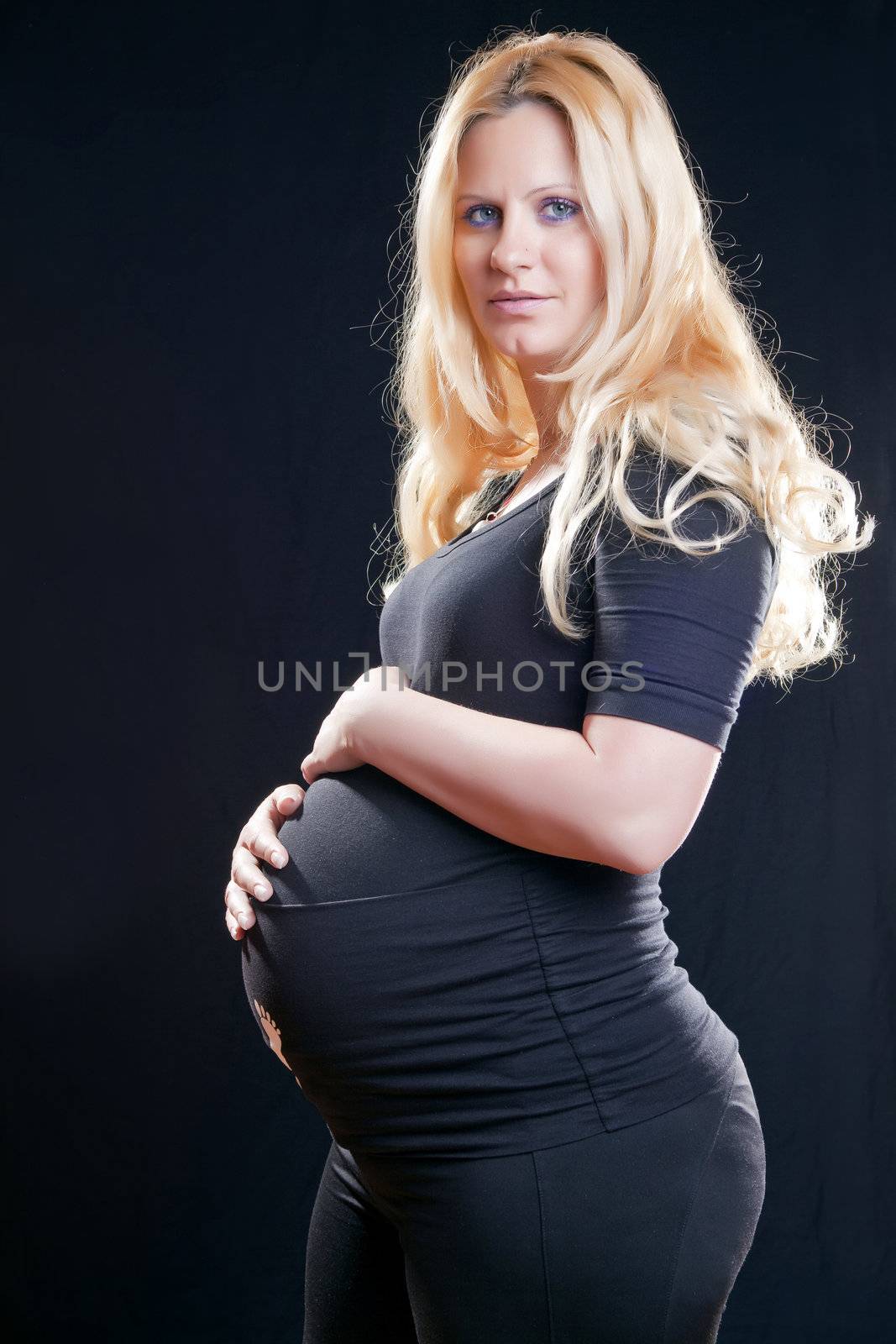 Pregnant woman holding tummy by adamr