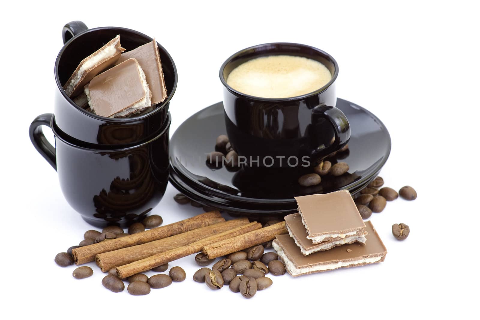 cup of italian espresso with cinnamon, coffee beans and chocolate