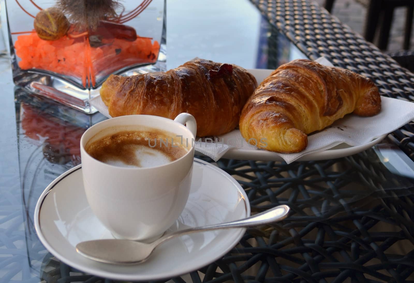 Espresso coffee and pastries on a table outside