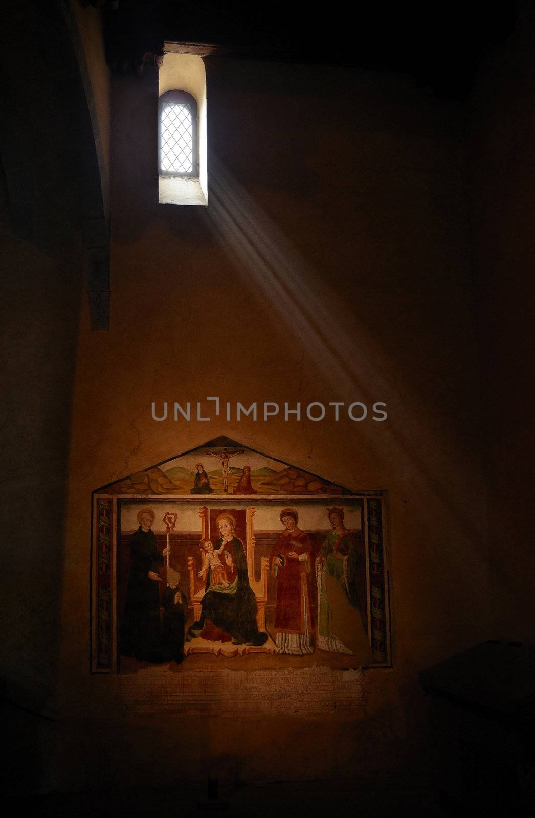 Church interior - Fresco religious painting under a beam of light from a small window