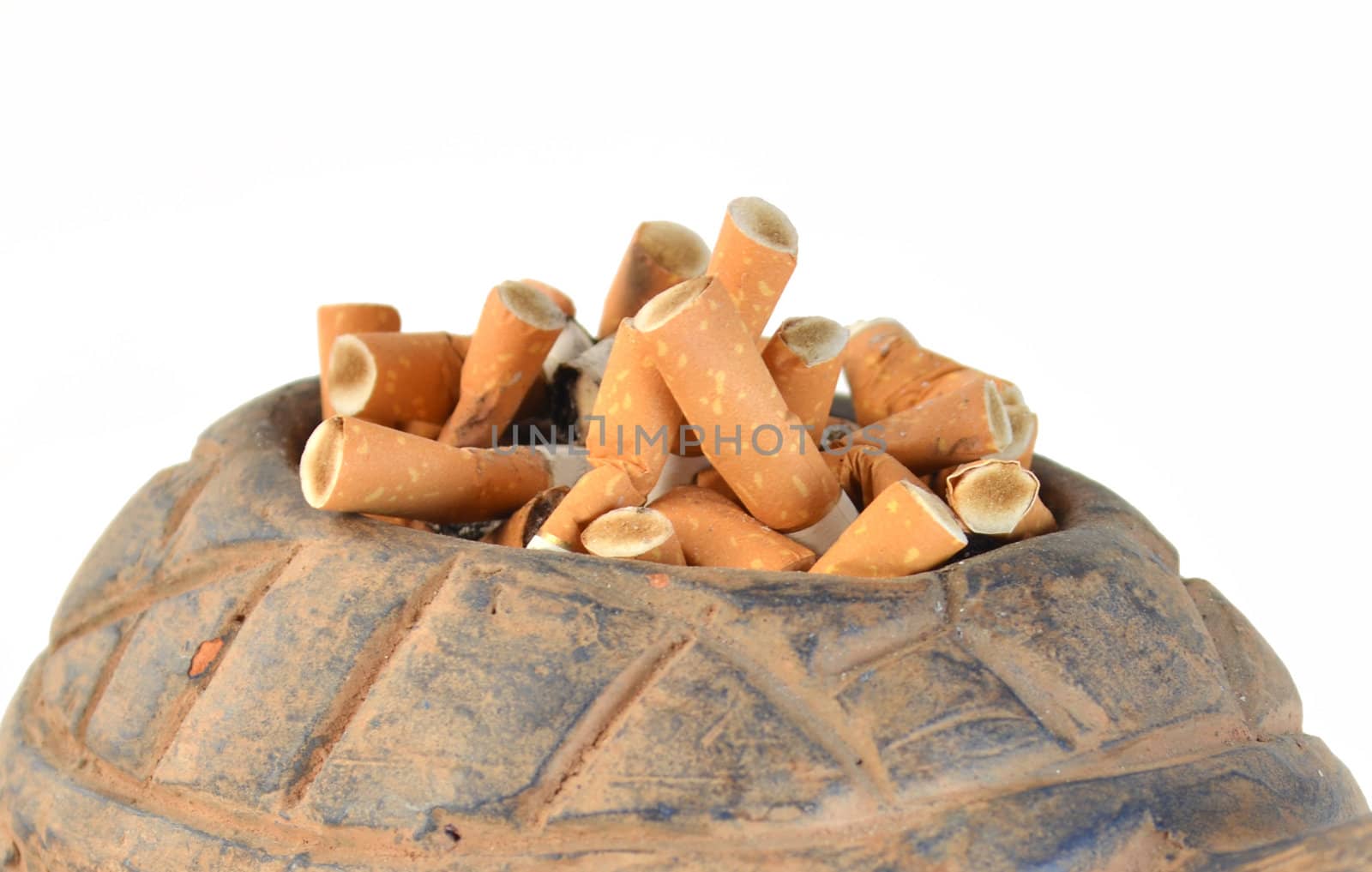 Cigarette butts in ashtray on white background