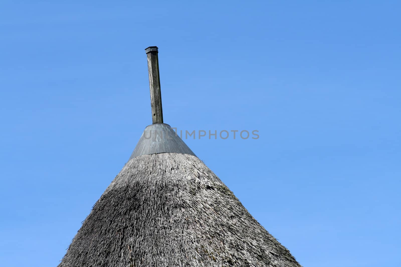 old african straw roof with blue sky