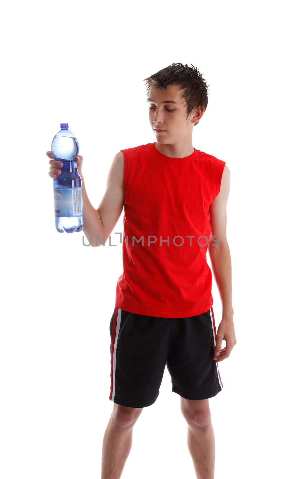 Teenager wearing gym clothes and holding a large bottle of water.  White background.