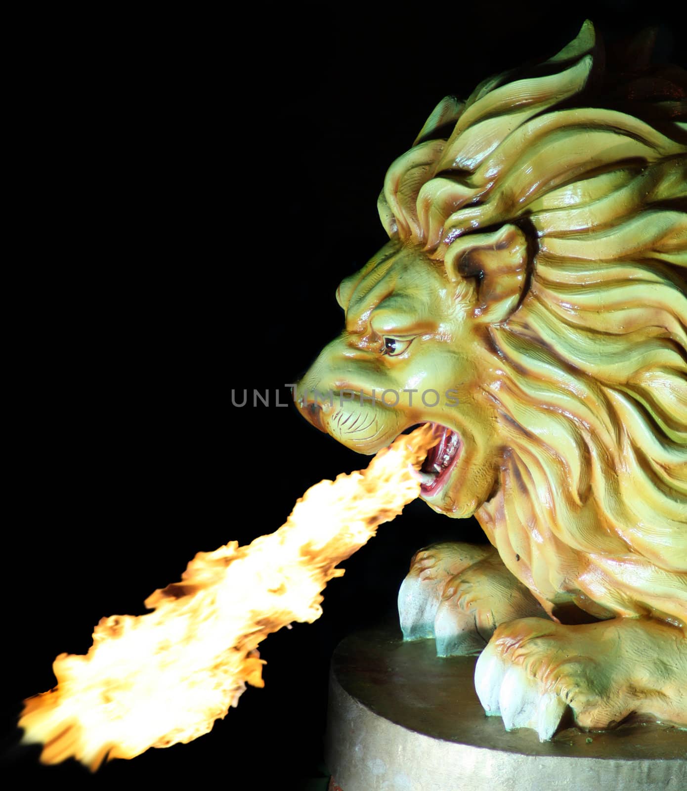 A sculpture of a lion spitting fire.