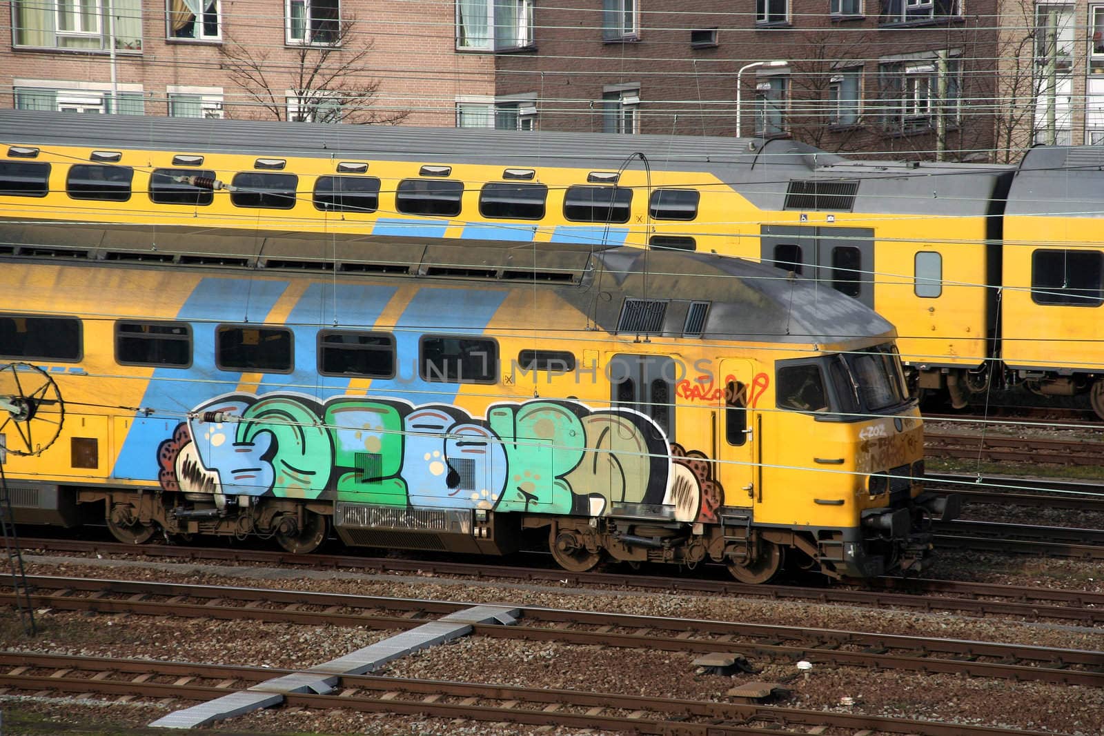 Grafitti on a train, with railroad tracks