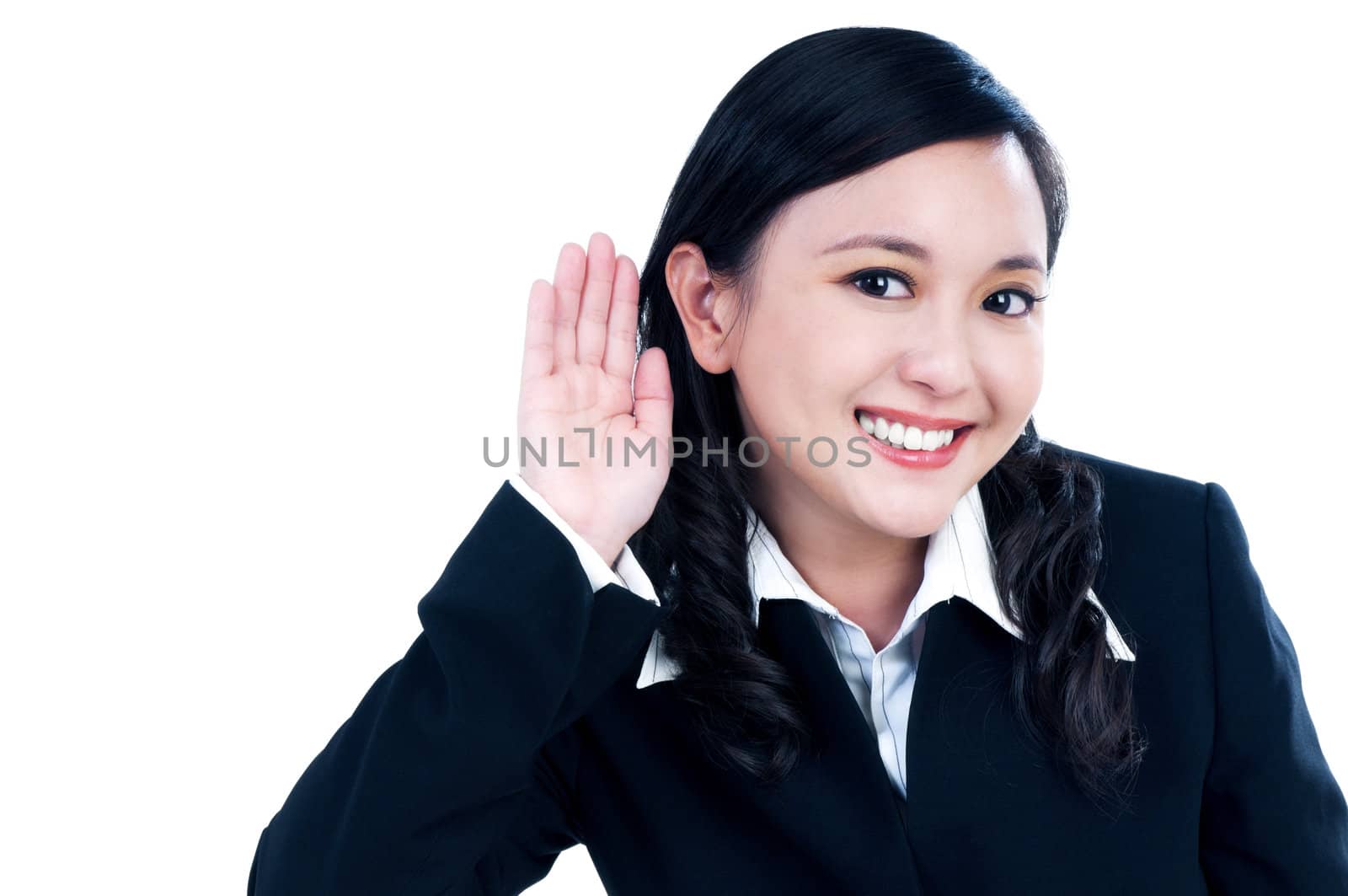 Portrait of a beautiful businesswoman putting her hand over ear, isolated on white.