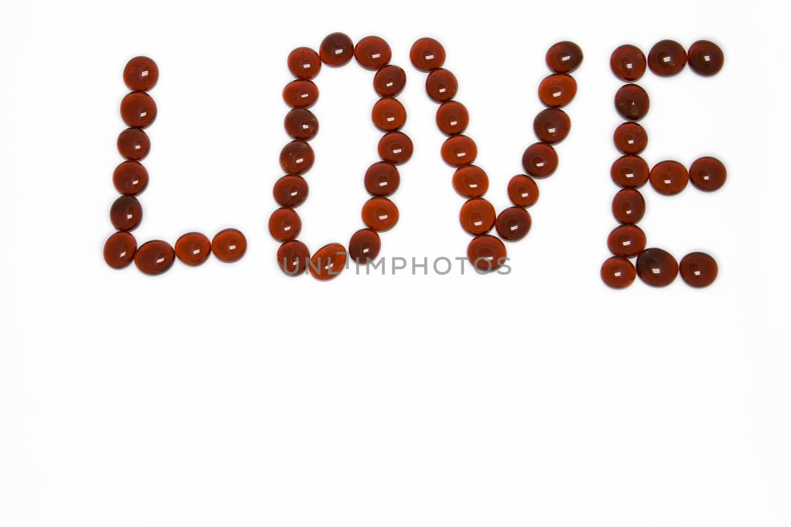 Love spelt in red gemstones on white background