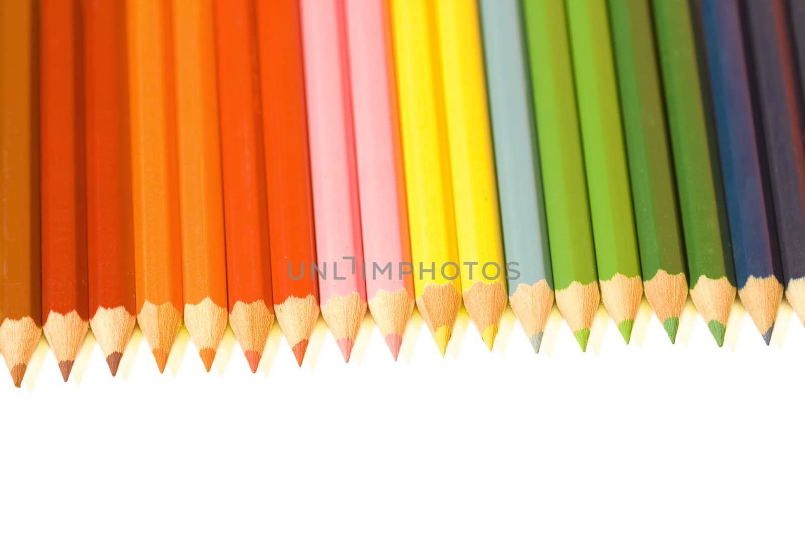 Coloured crayon rainbow on white background