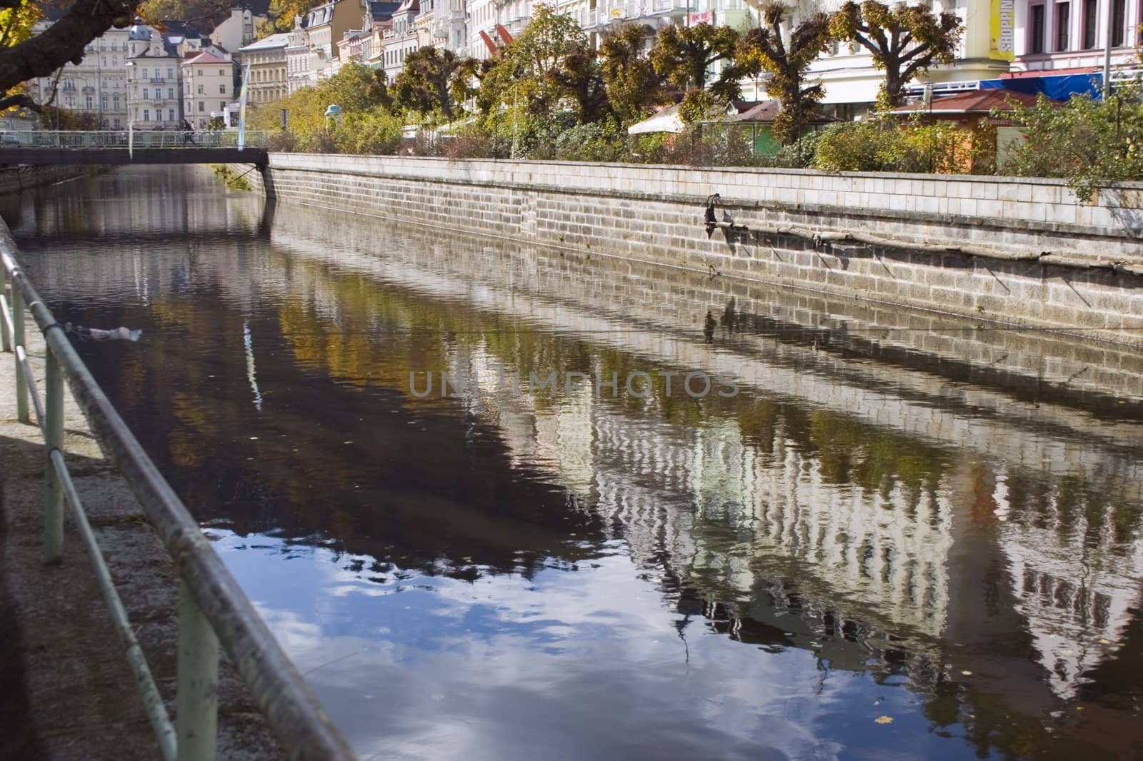 city boulevard in Bohemian spa mirrored in the river