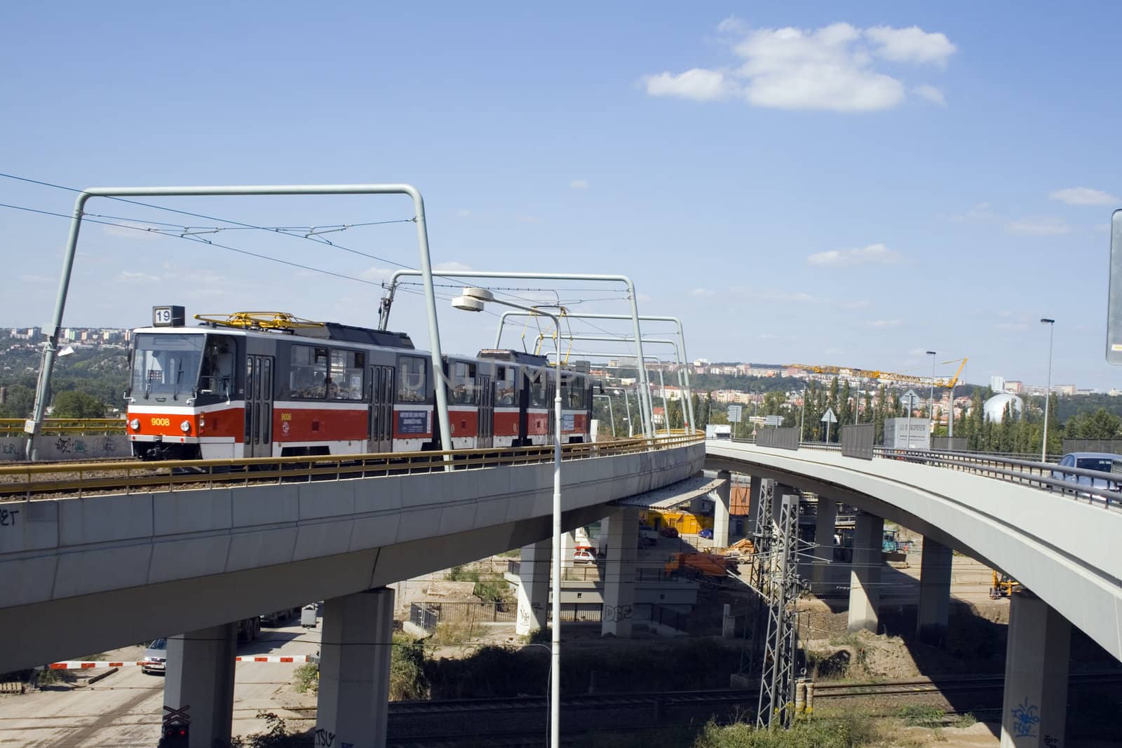 a new tram going down a new bridge in the city