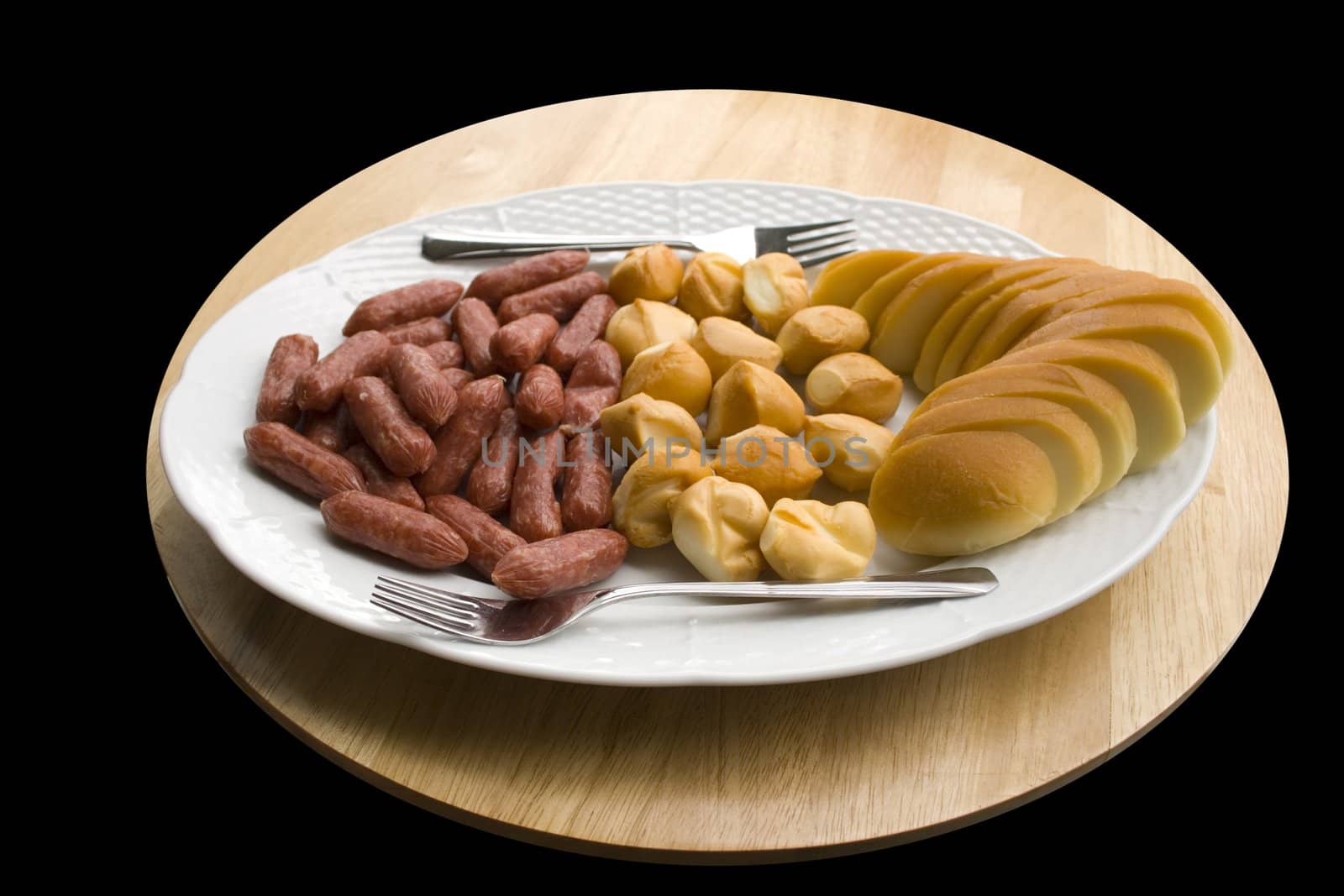 A plate of cheese and sausages - close up