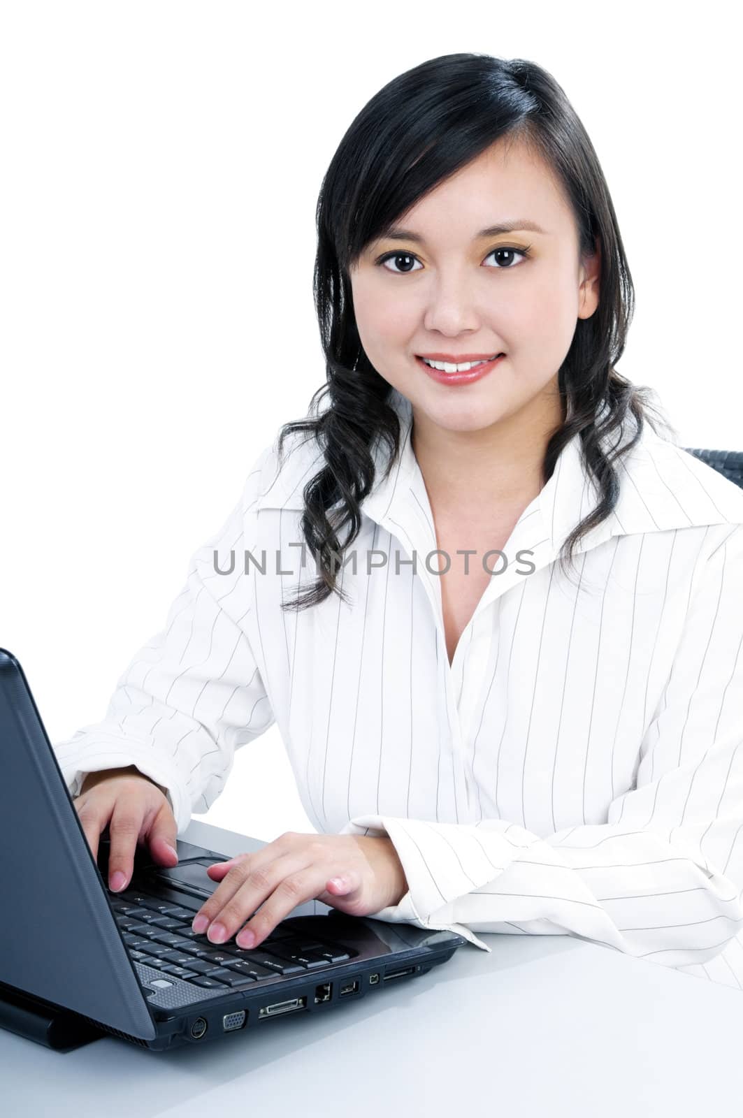 Portrait of a young businesswoman using laptop, over white background.
