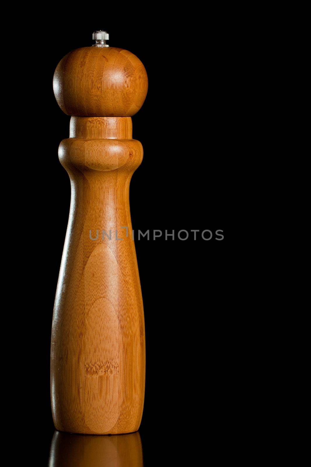 Wooden salt or pepper grinder isolated over black