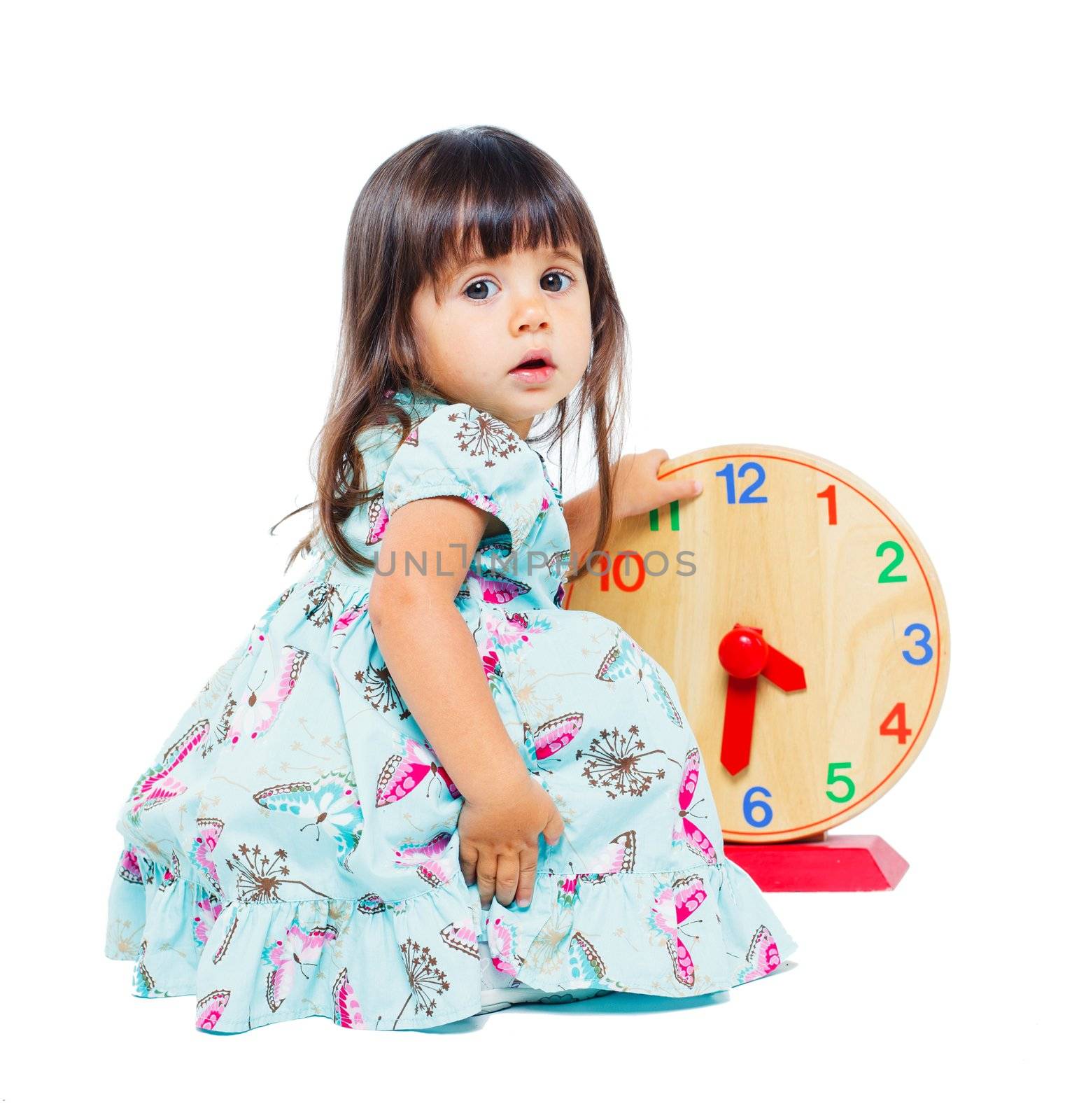 Clouse-up portrait pretty little girl with clock. Isolated. In studio
