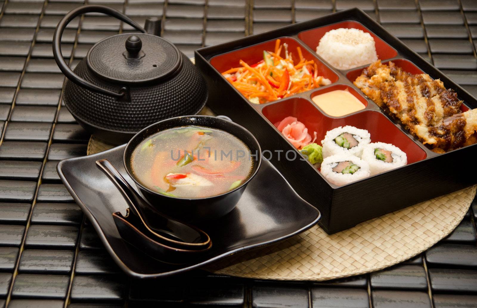 Sushi lunch with soup salad tea and sauce