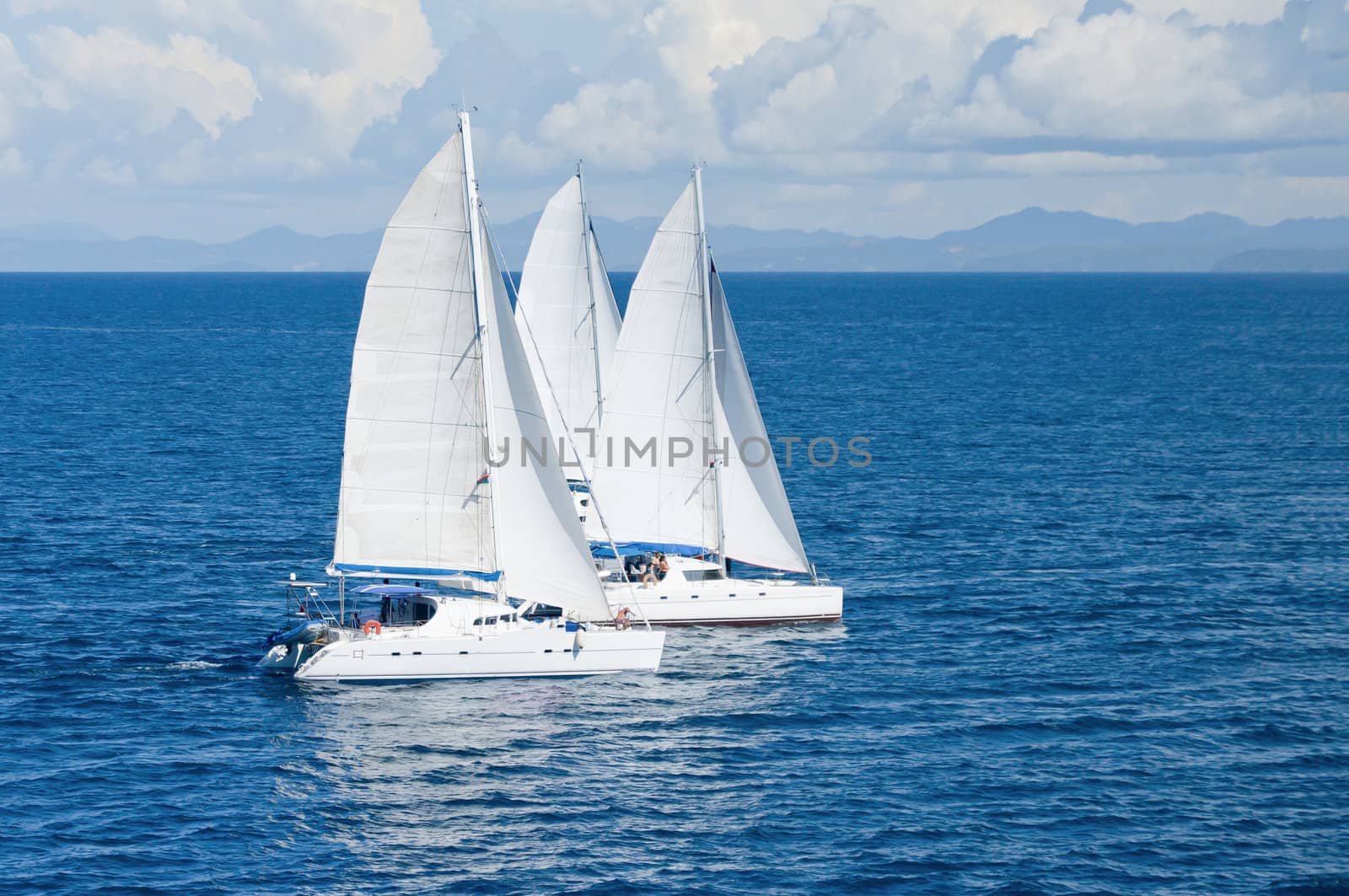 Three sailboats racing in the Indian Ocean