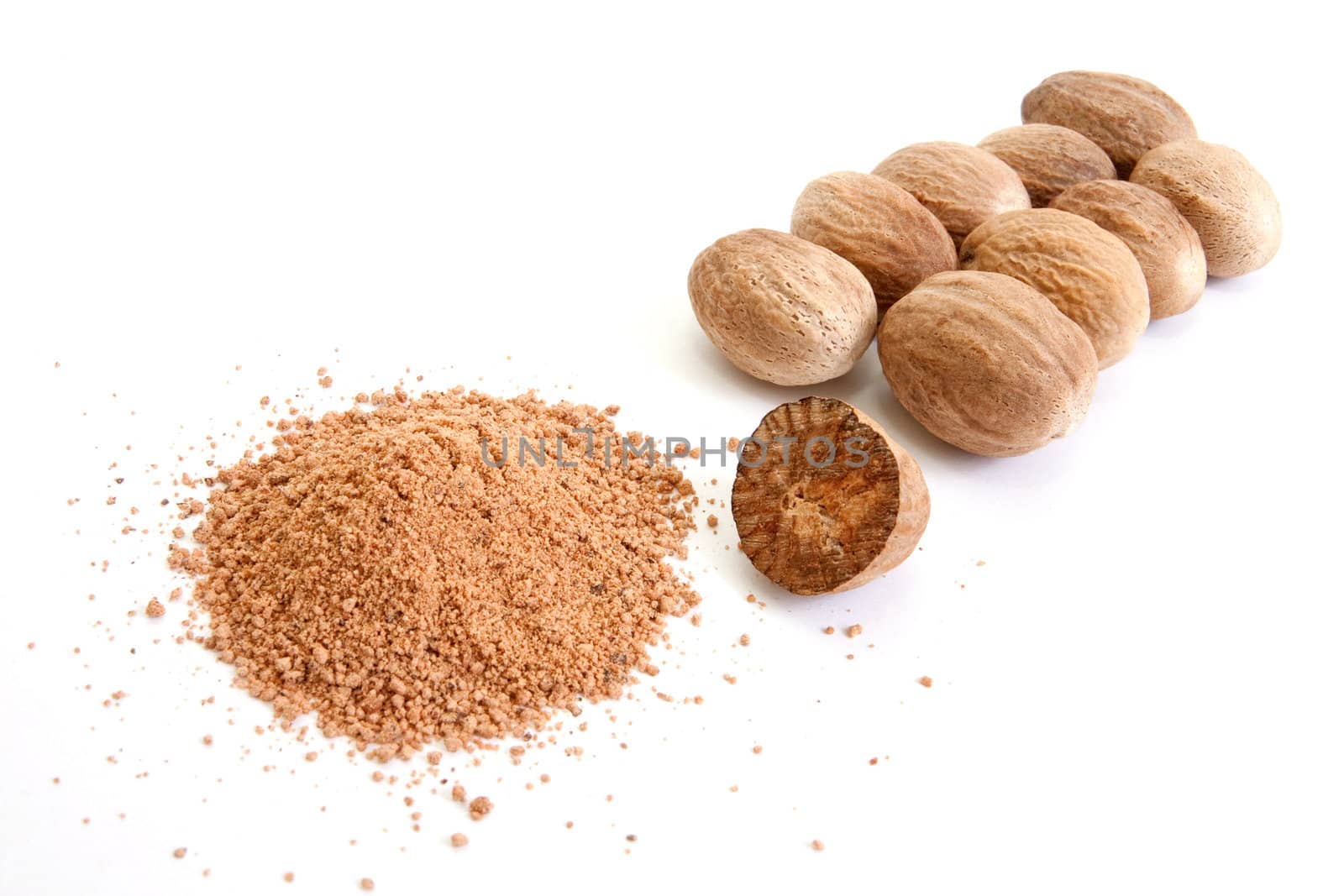 Whole and grated nutmeg isolated on white background