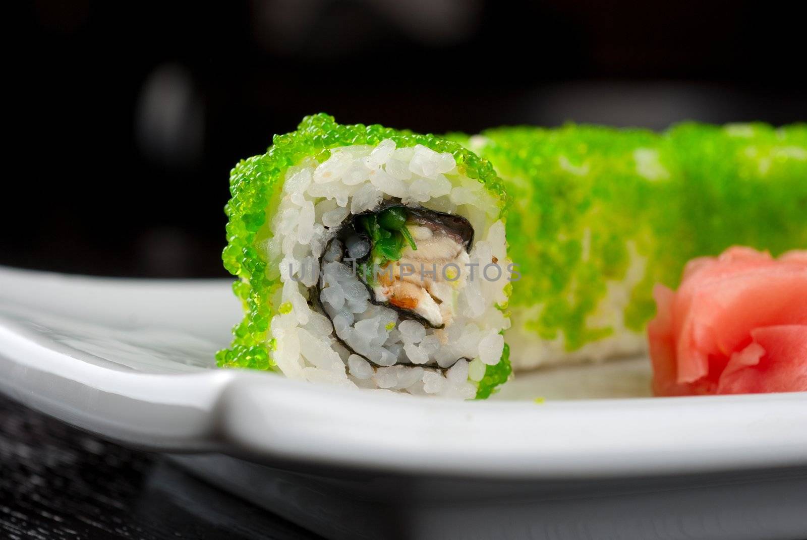 Sushi rolls made of salmon, avocado, flying fish roe - tobiko caviar and philadelphia cheese