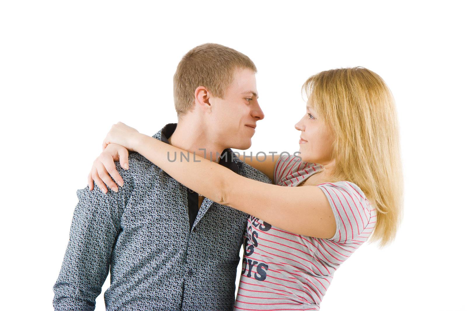 on a white background happy young couple hugging
