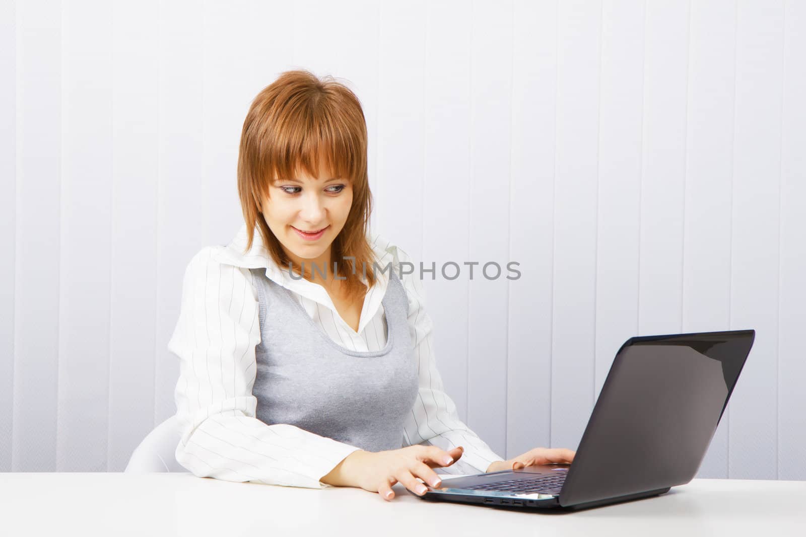 attractive young girl with surprise stares at the monitor laptop
