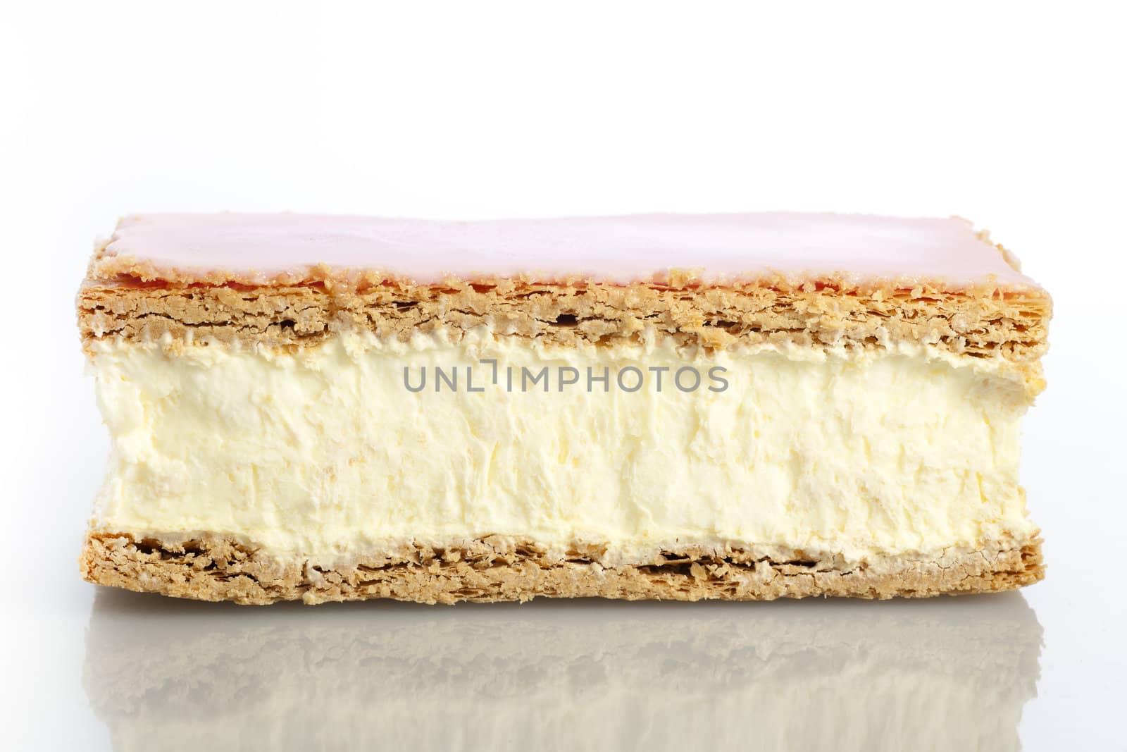 Tompouce, a common pastry  in the Netherlands and Belgium made  with puff pastry , filled with sweet yellow pastry cream and topped with pink icing.