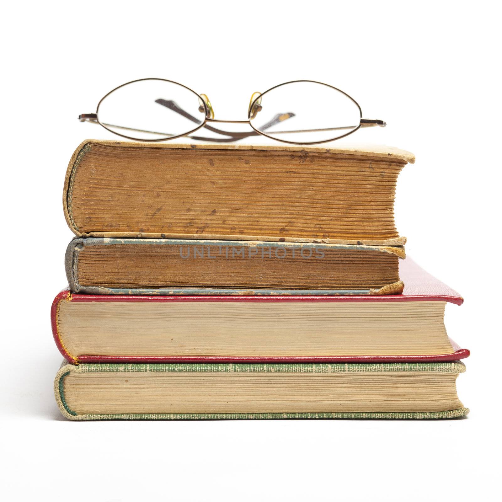 Group of Old Antique Books and eyeglasses isolated on white