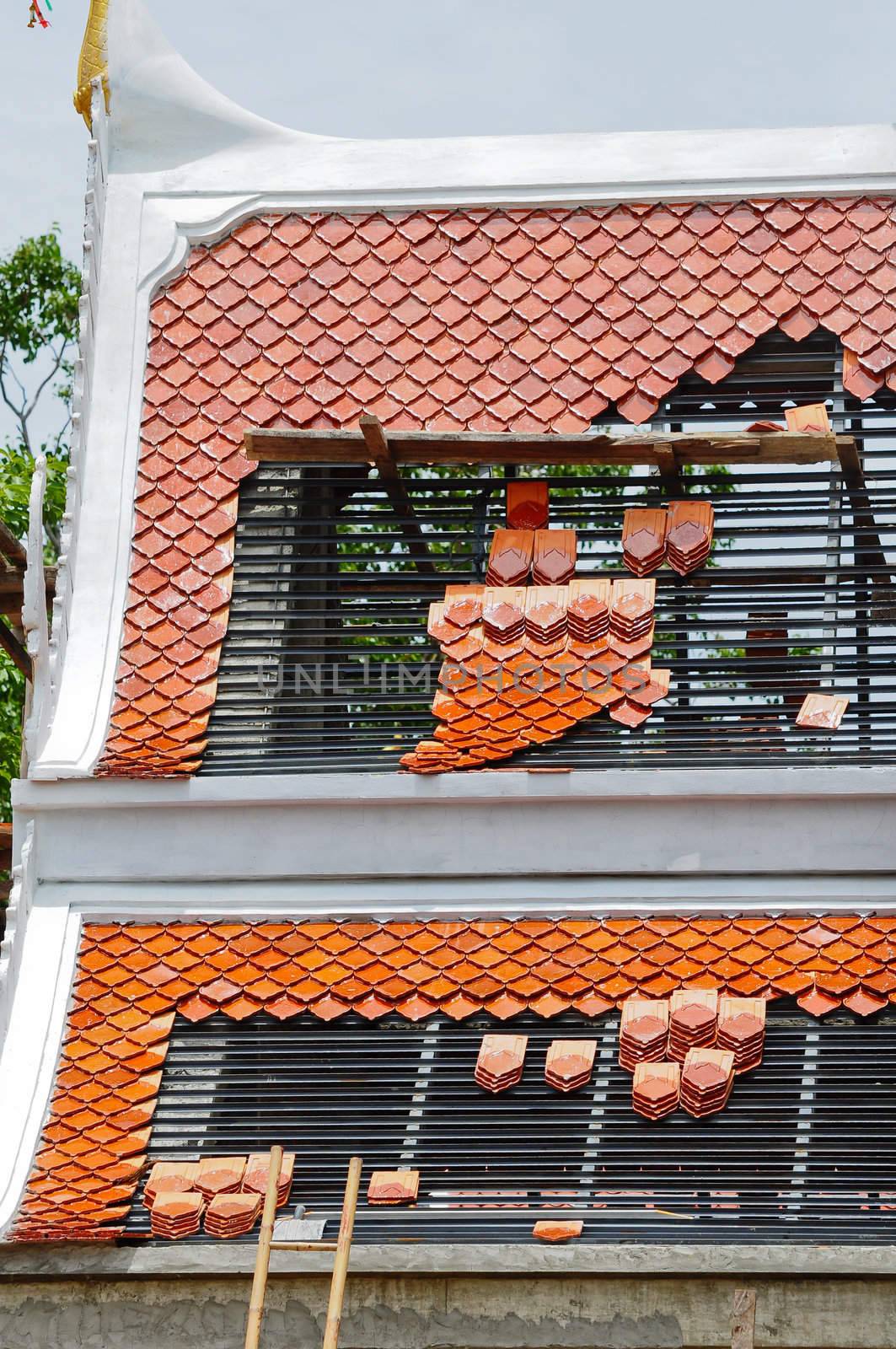 Repairing the roof of a temple in Thailand