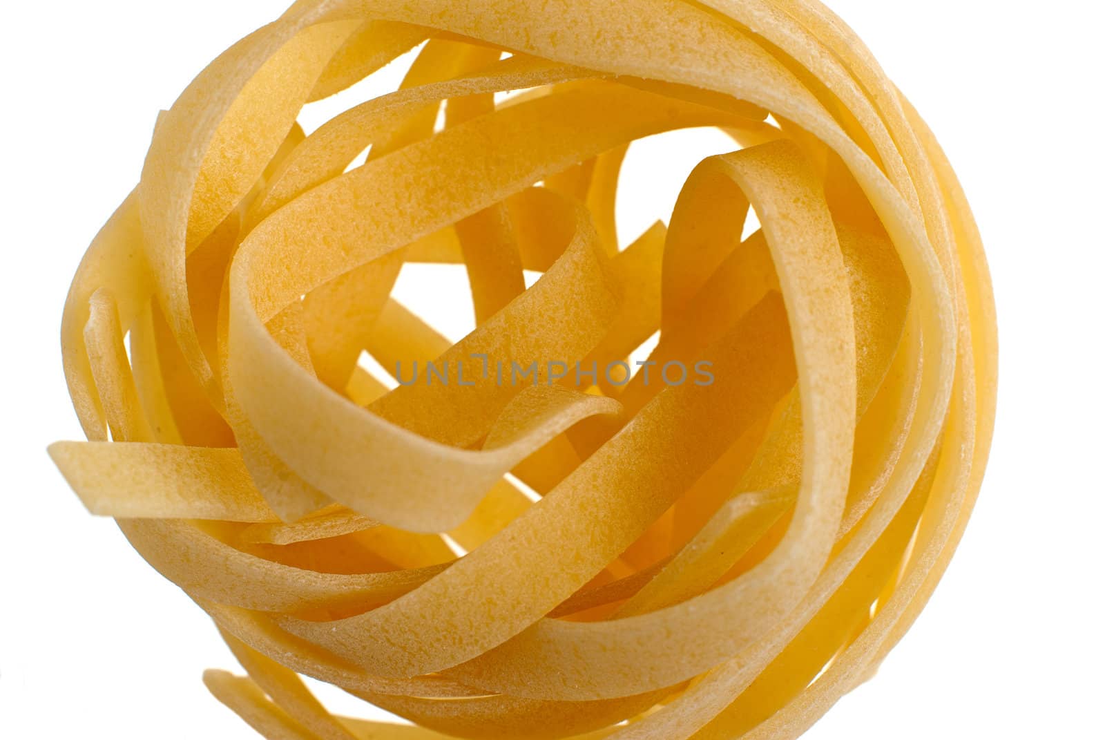 Italian pasta tagliatelle selective focus macro detail isolated on white background.