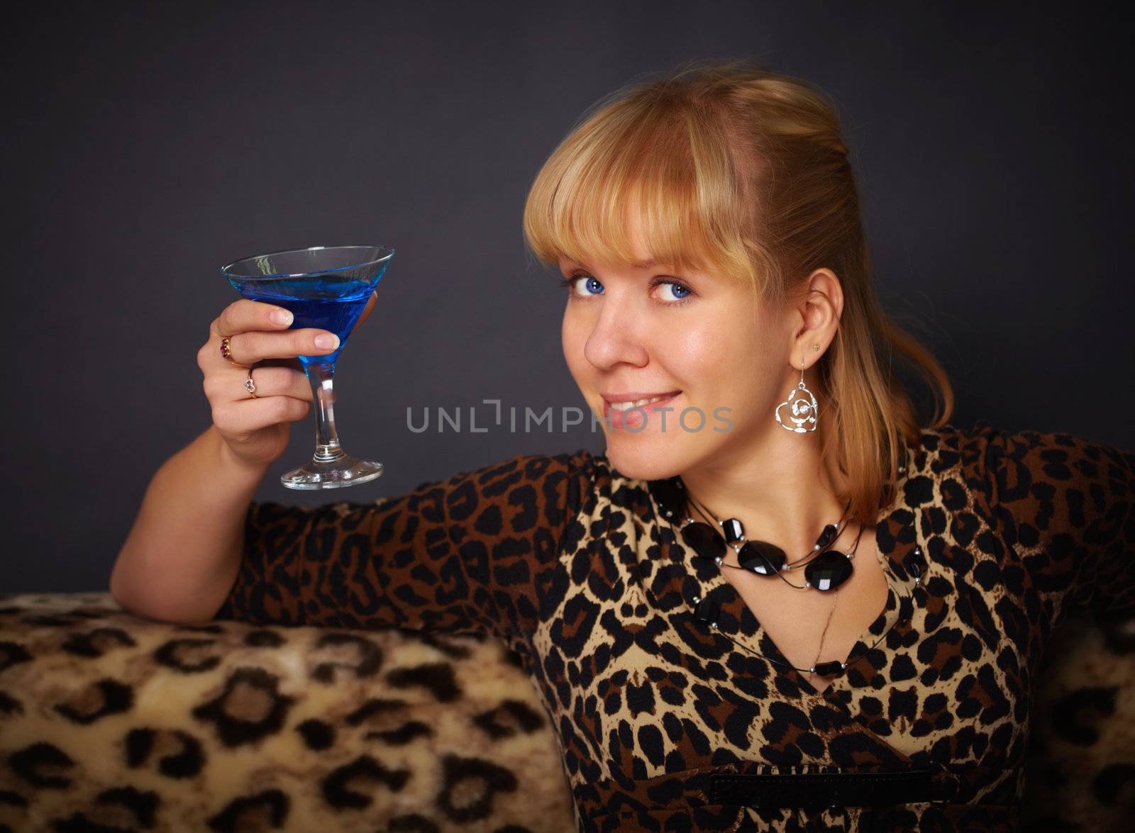 Beautiful young woman drinking blue cocktail by pzaxe