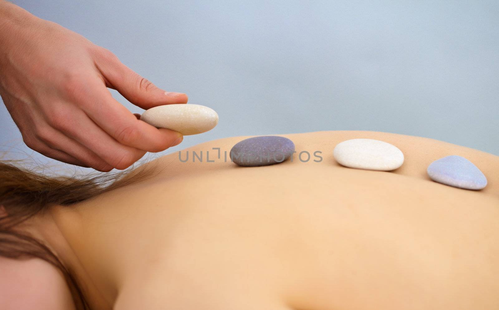 Massage procedure using round stones - Spa, close up