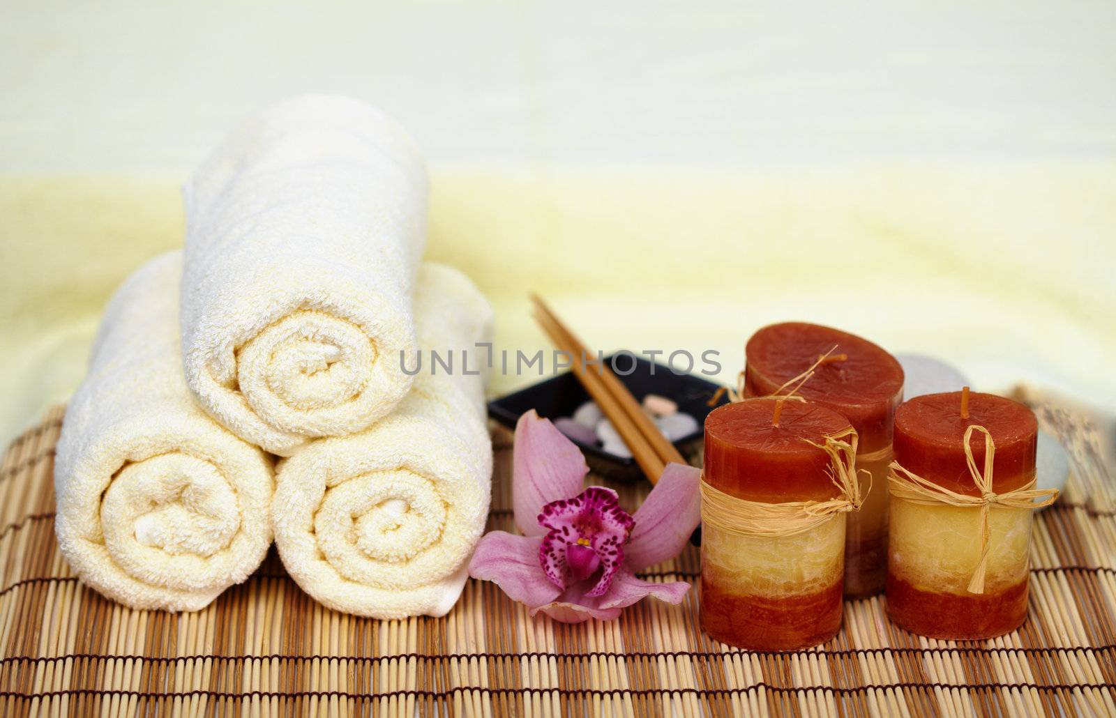 Still life on a theme a spa - a candle, mat, towels