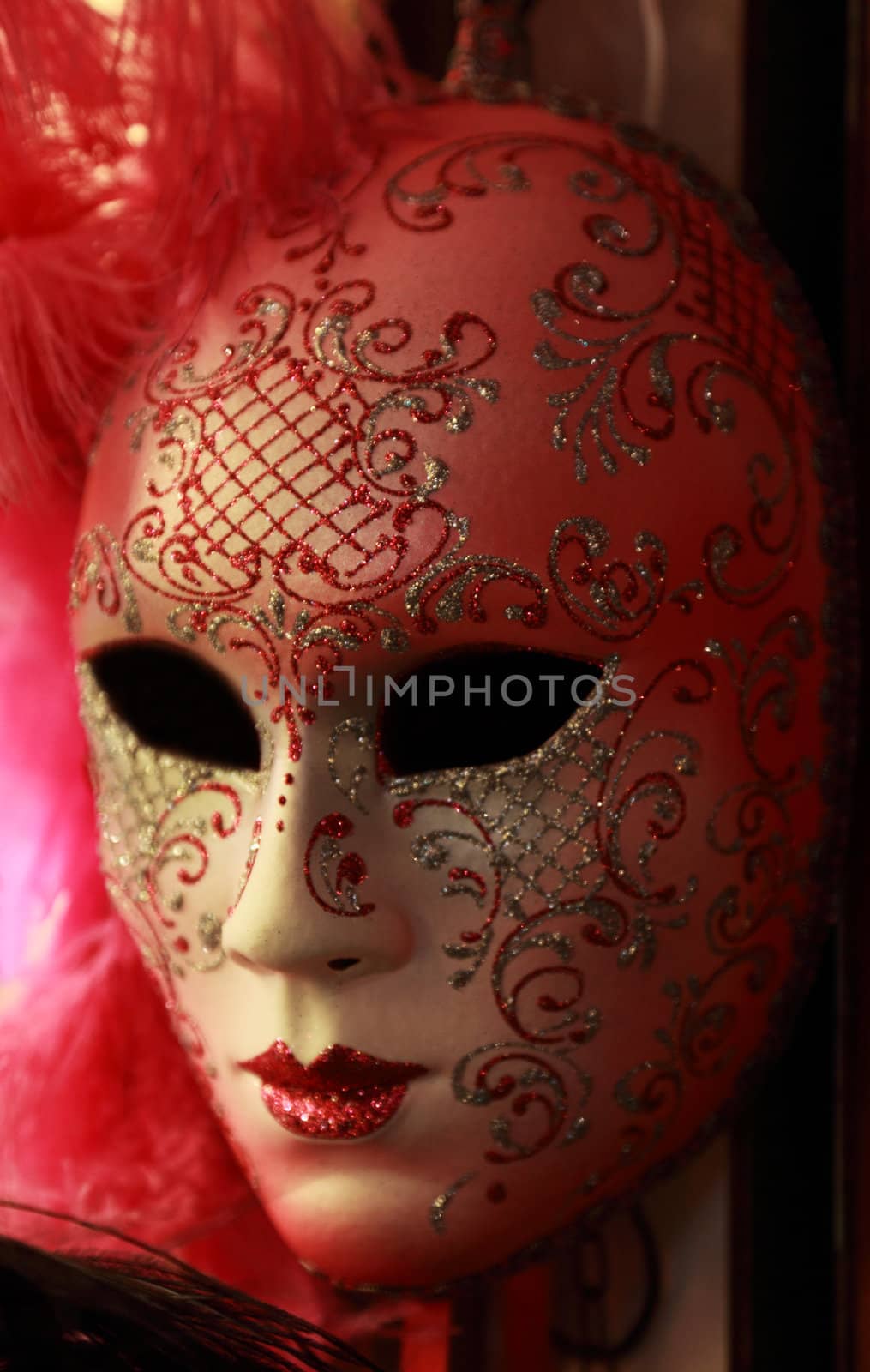 Image of a beautiful Venetian mask on a souvenir shop stand in natural lighting conditions.Soft focus.