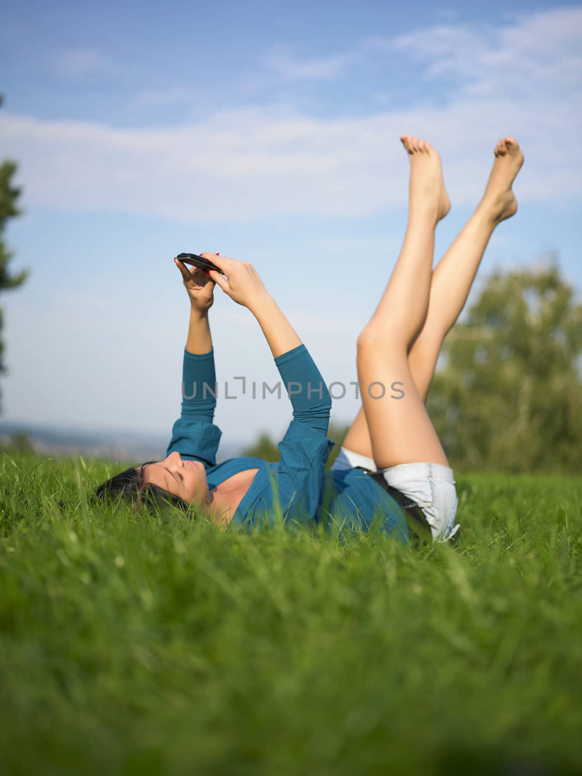 Young woman using laptop in park