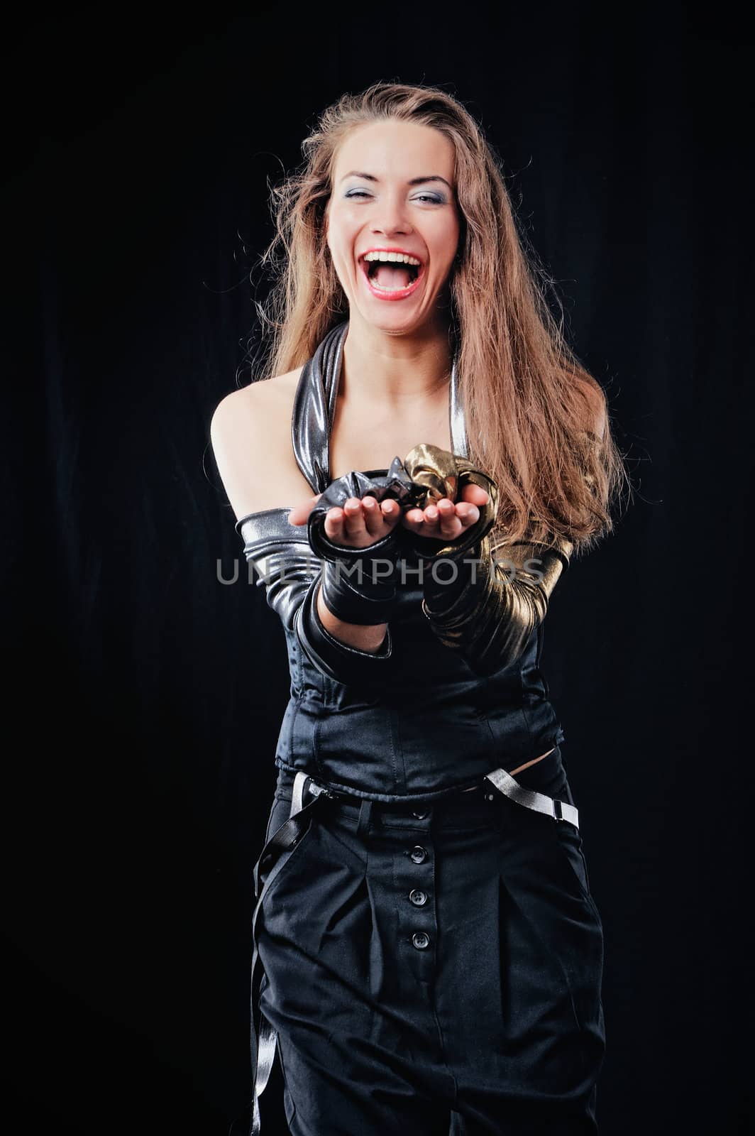 Joyful woman with long brown hairs. Isolated on black