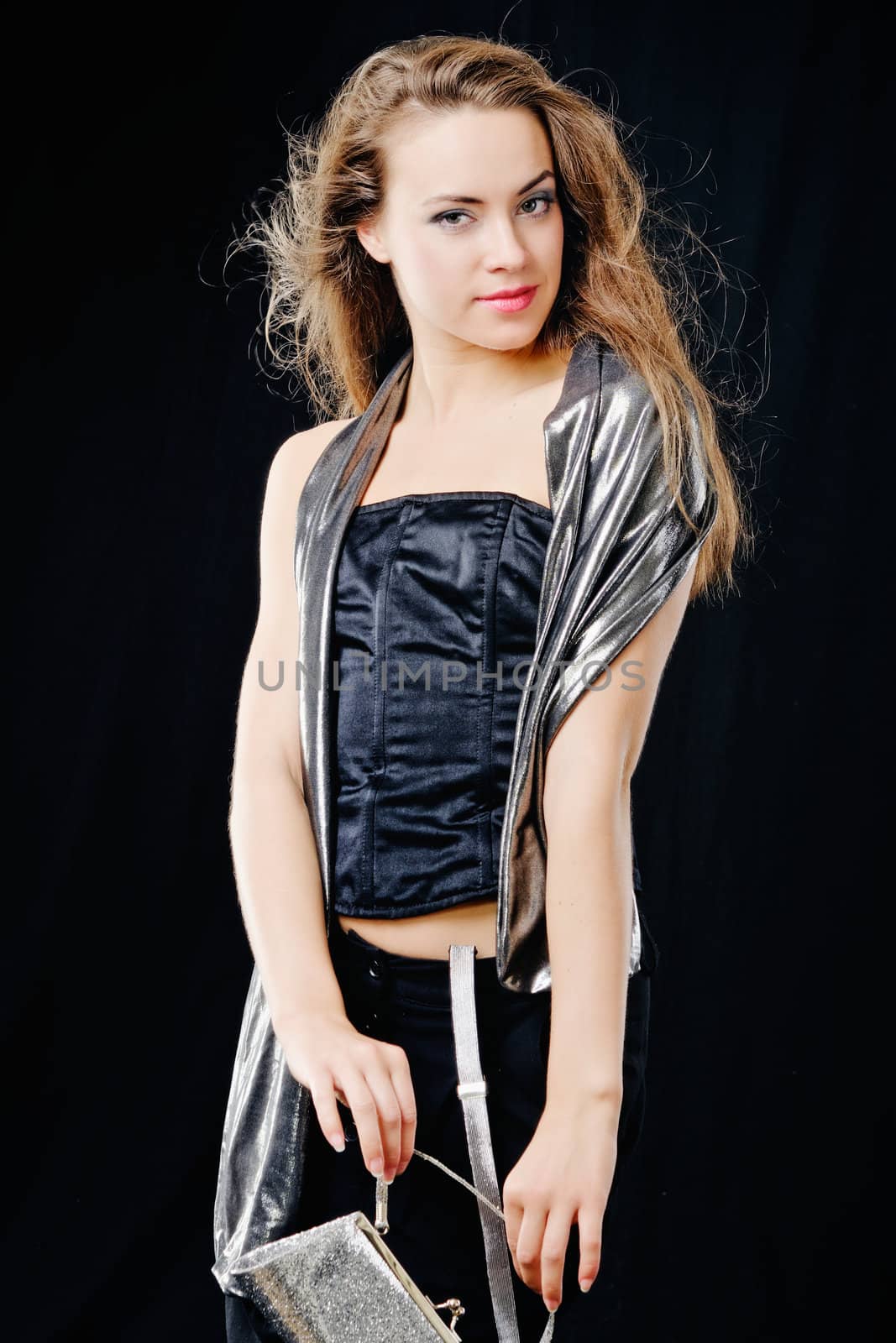 Young woman with long brown hairs. Isolated on black