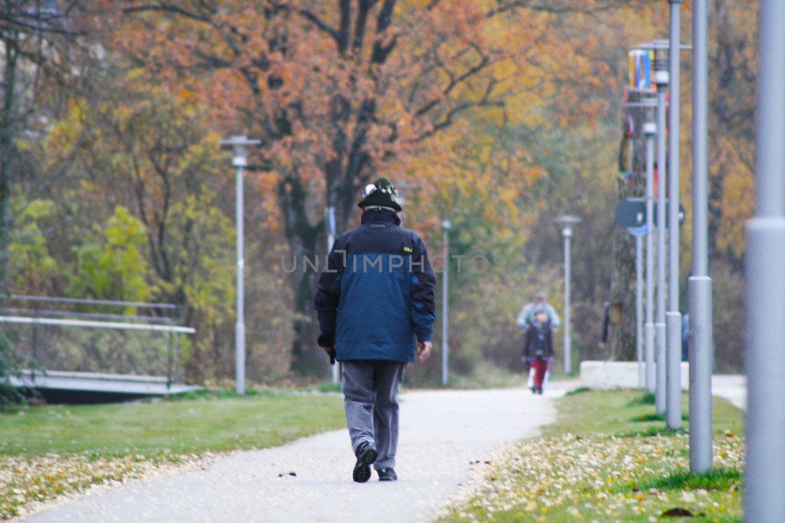 An old man walks in October