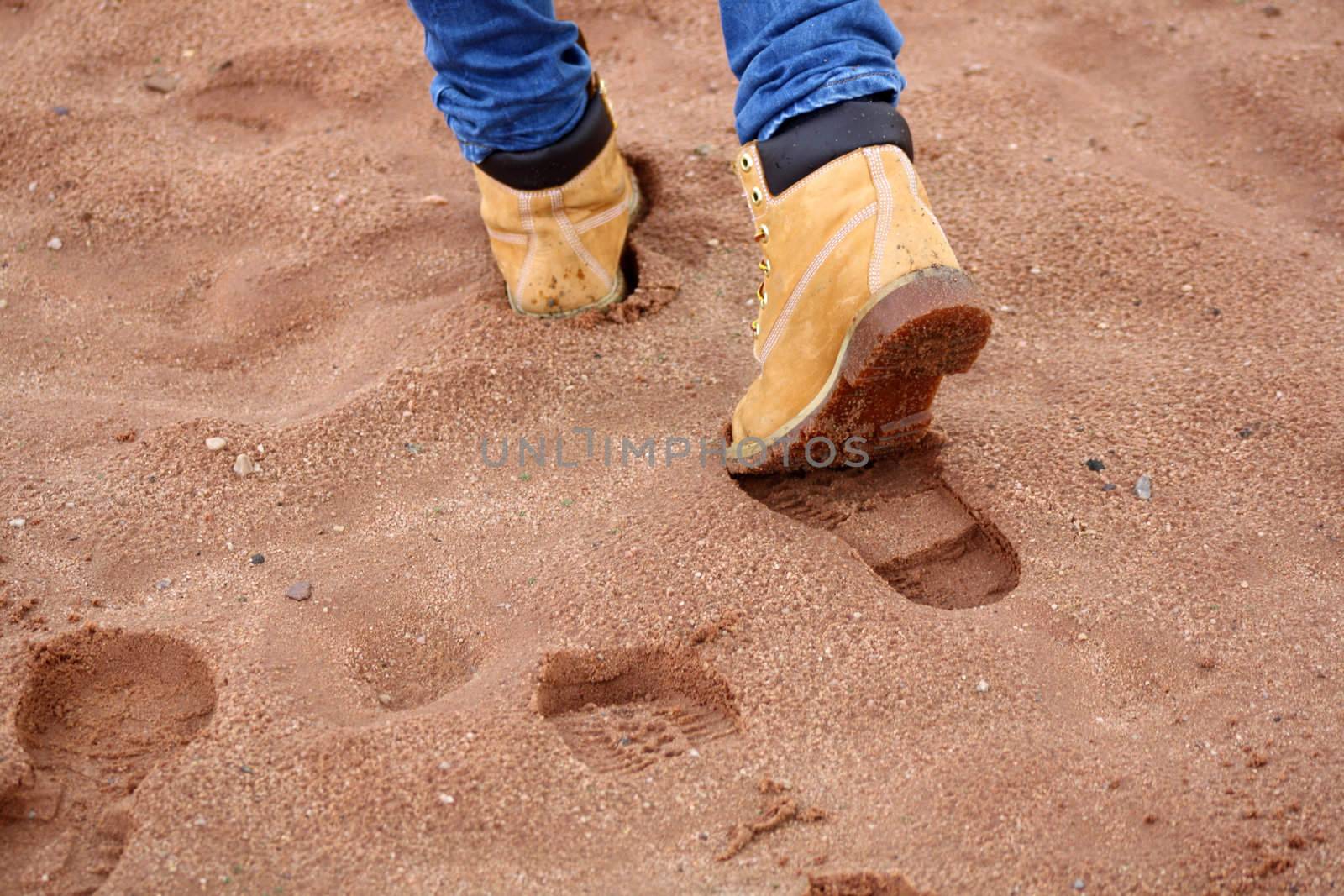 Human footprints on sandy beach