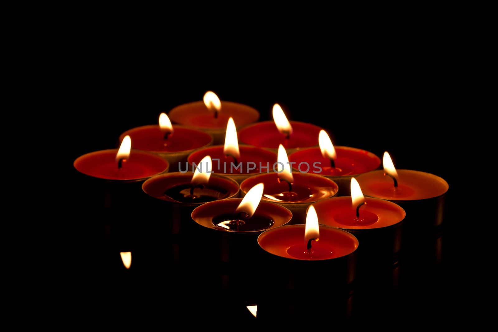 colored candles on black background