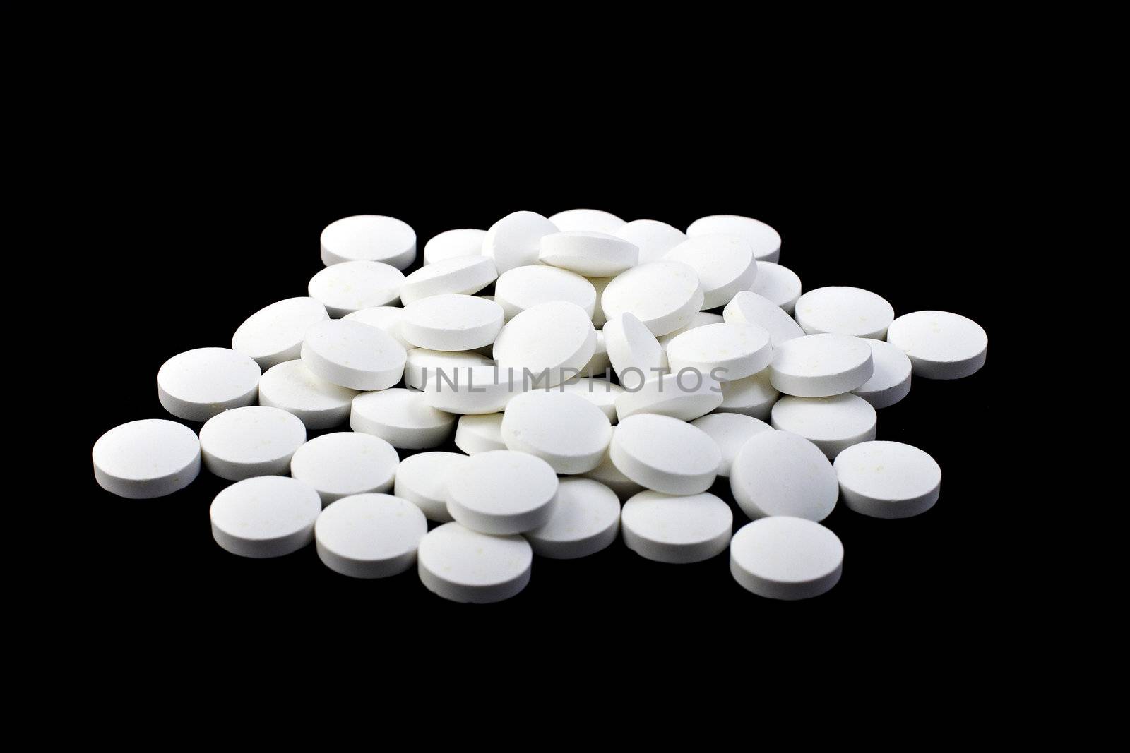 A handful of pills on a black background, isolated