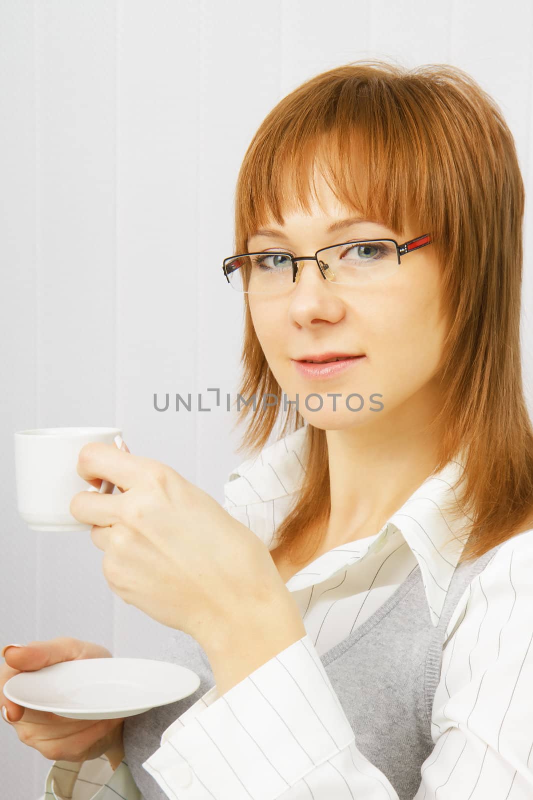 attractive girl in glasses with a cup of coffee in hand