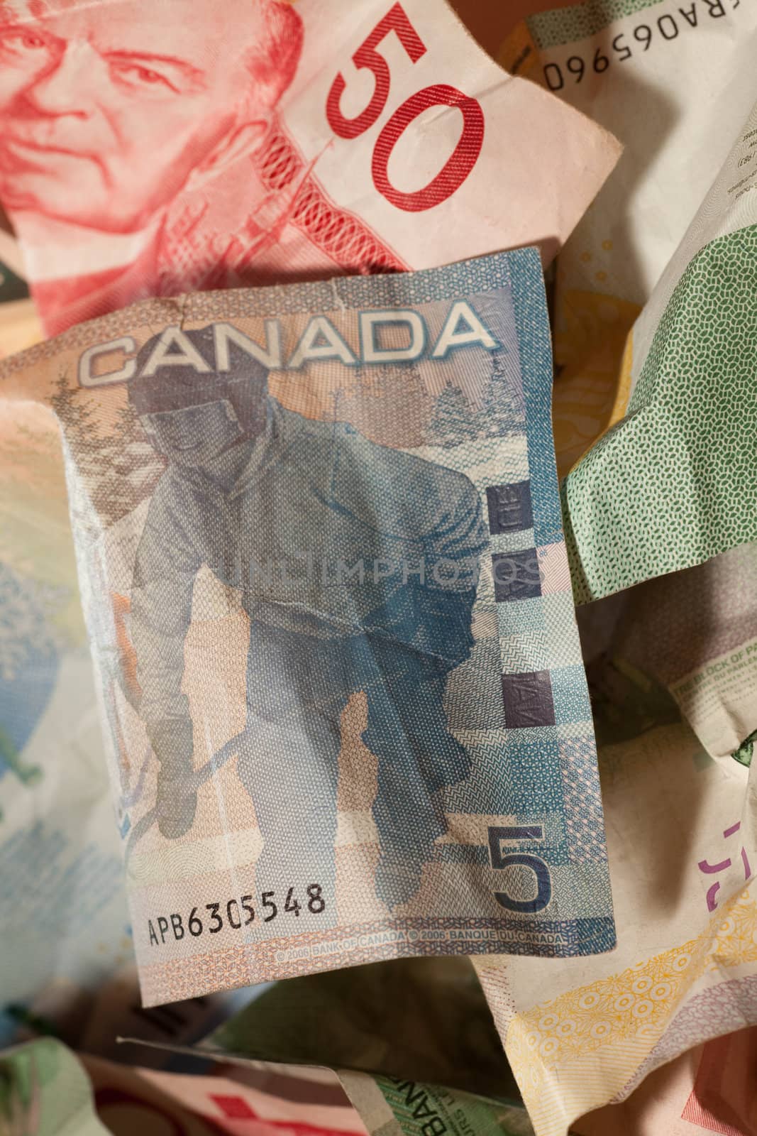 Crumpled Canadian dollar bills close-up, currency crisis concept