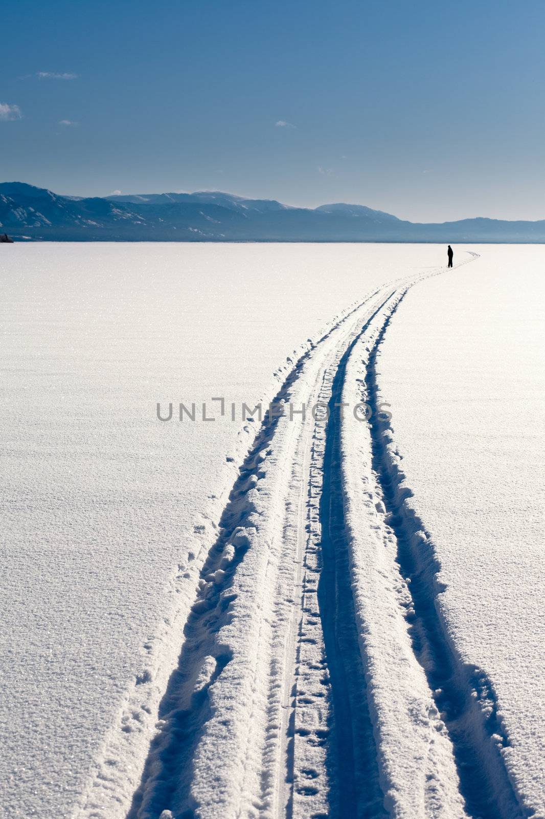 Skiing person on frozen lake by PiLens