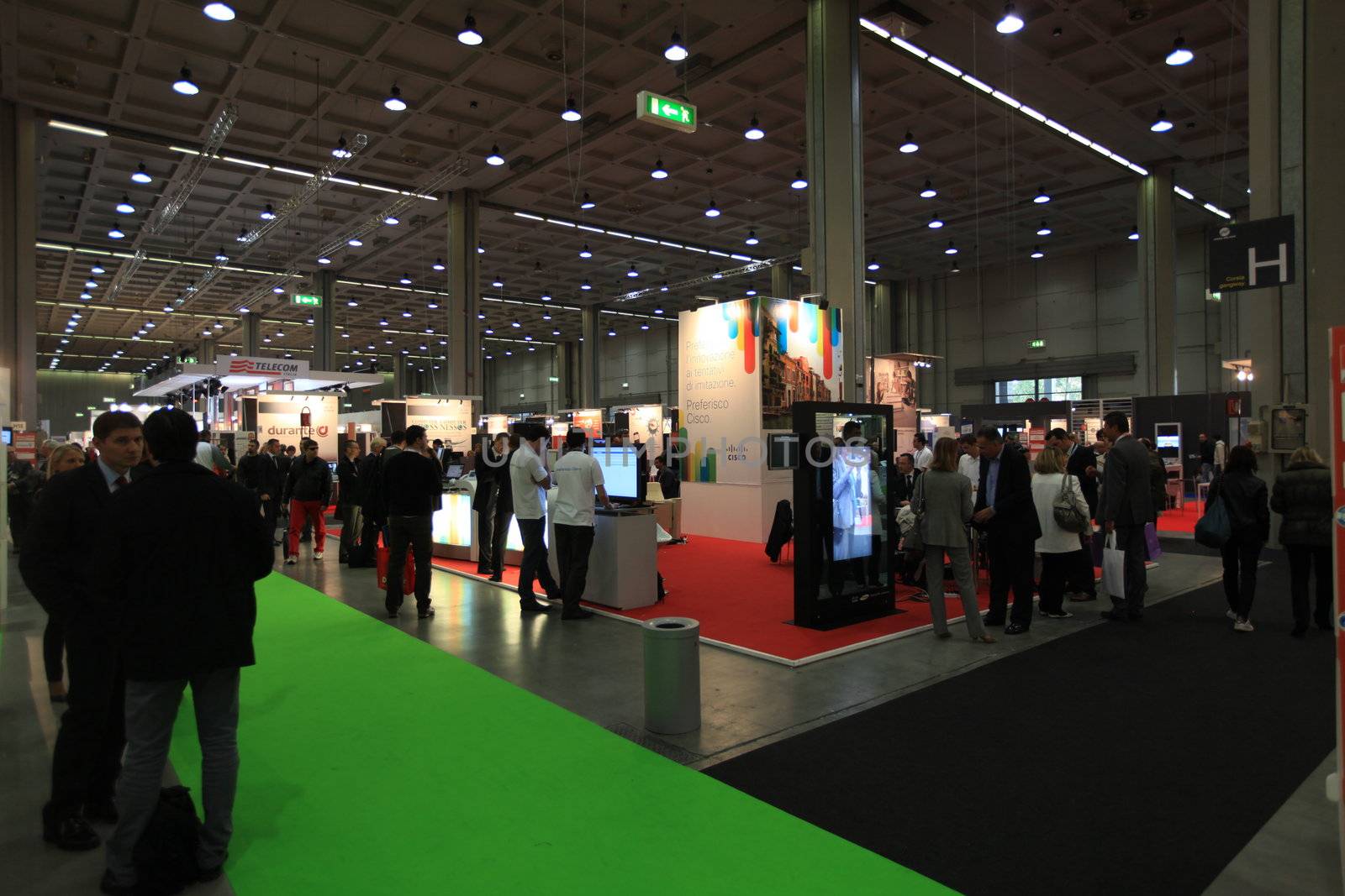 Panoramic view of people visiting technologies stands during SMAU, international fair of business intelligence and information technology in Milan, Italy.